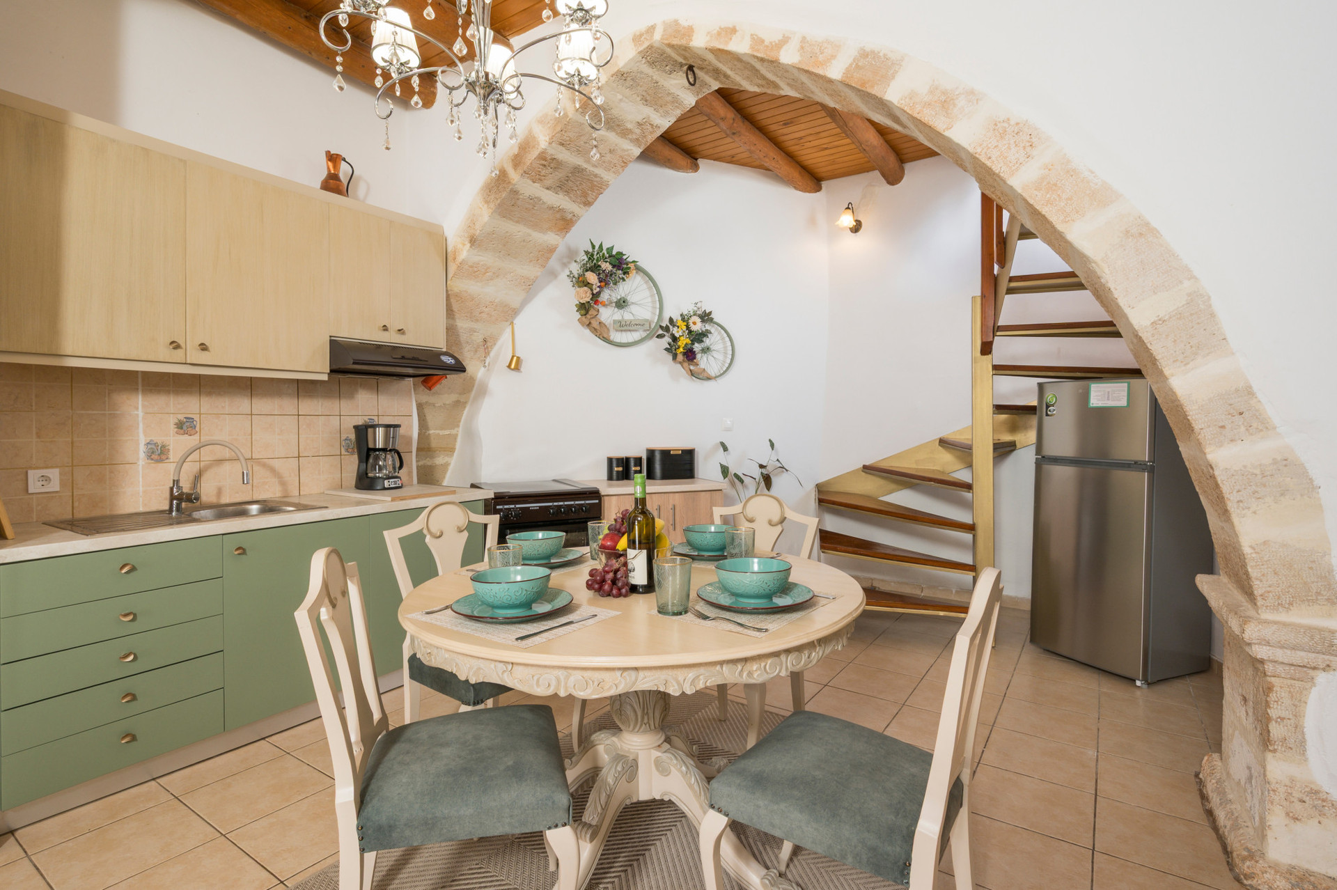 The ground floor features an open-plan dining area, living room, and kitchen, with a staircase leading up to the bedroom.