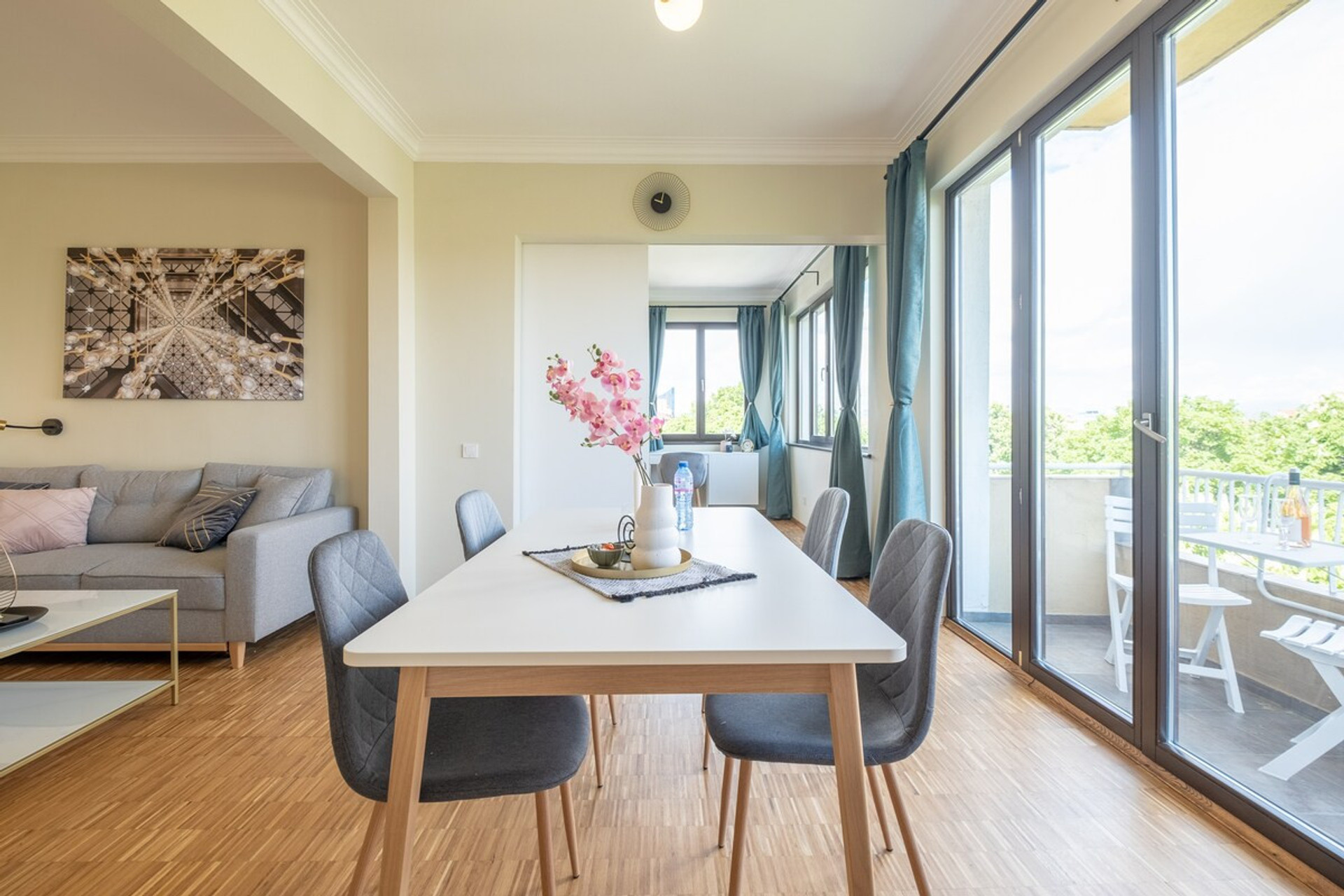 Spacious dining area with a table for four, surrounded by floor-to-ceiling windows that fill the room with natural light. Enjoy meals with a stunning view of NDK and access to the private balcony for a true Sofia experience.