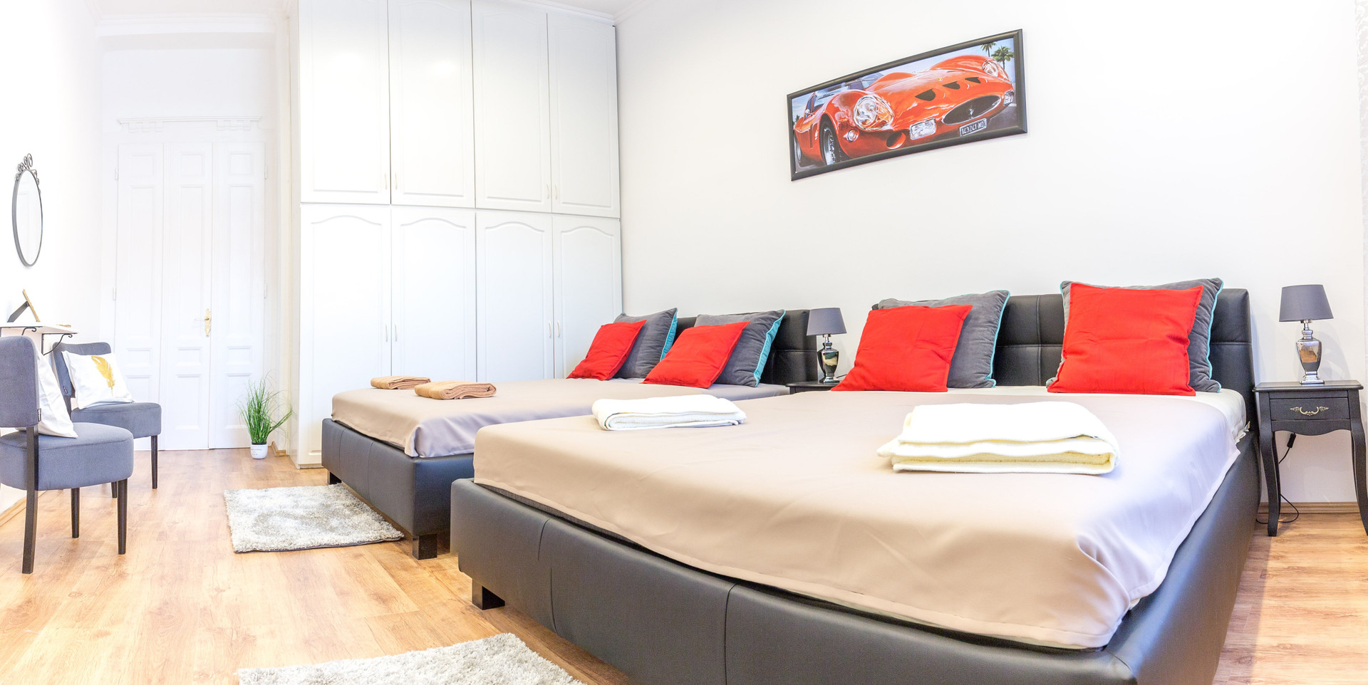 Twin beds with red pillows