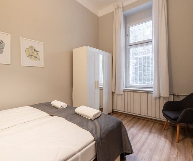 Bedroom with wardrobe and armchair