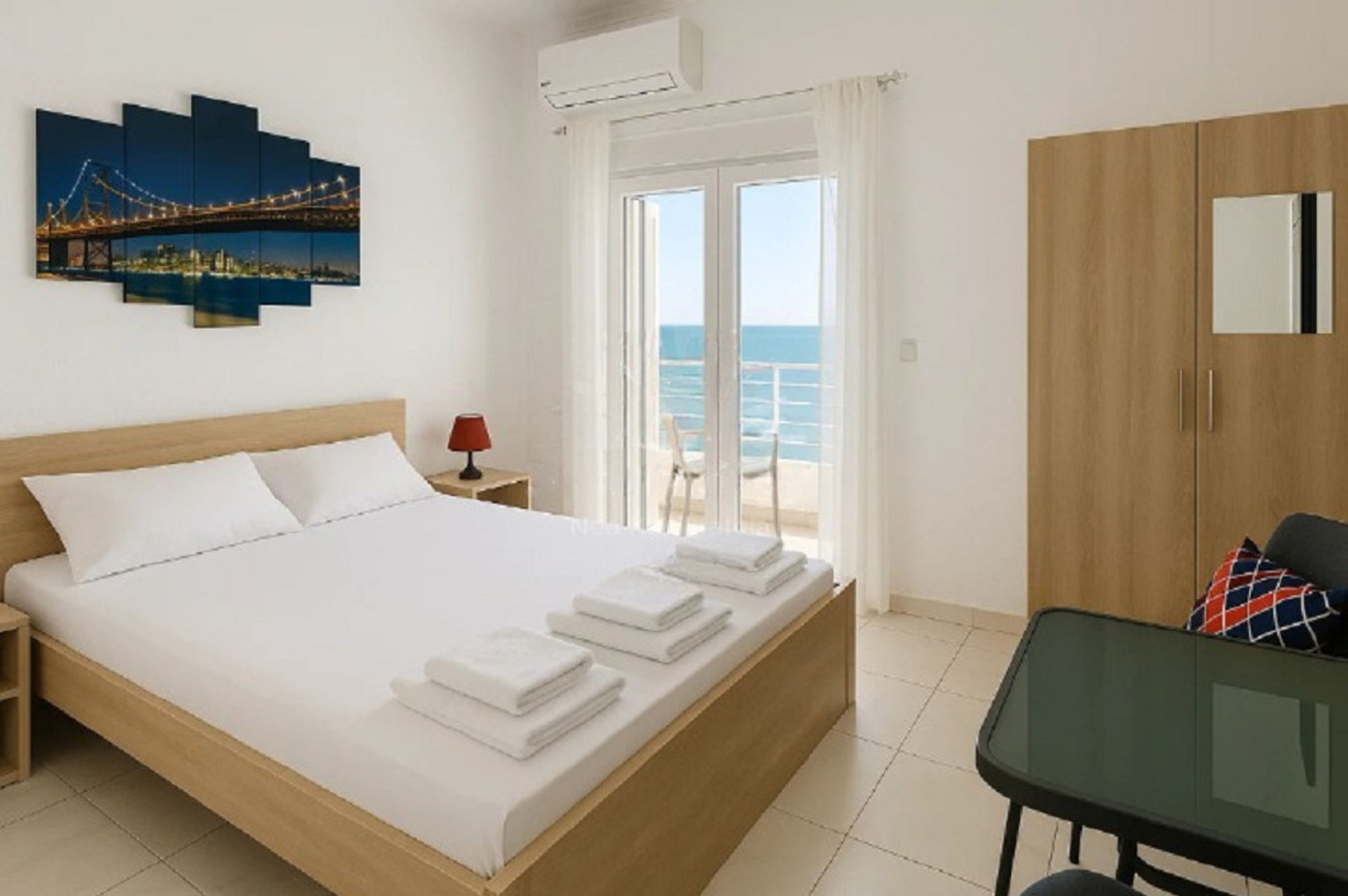 Spacious master bedroom with a large, comfortable double bed and a clean, minimalist design