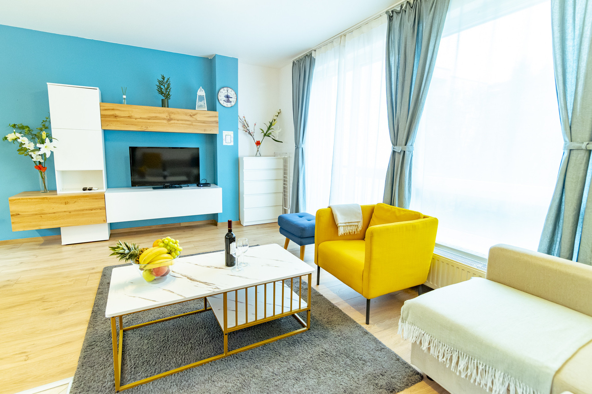 Living room TV blue wall yellow armchair