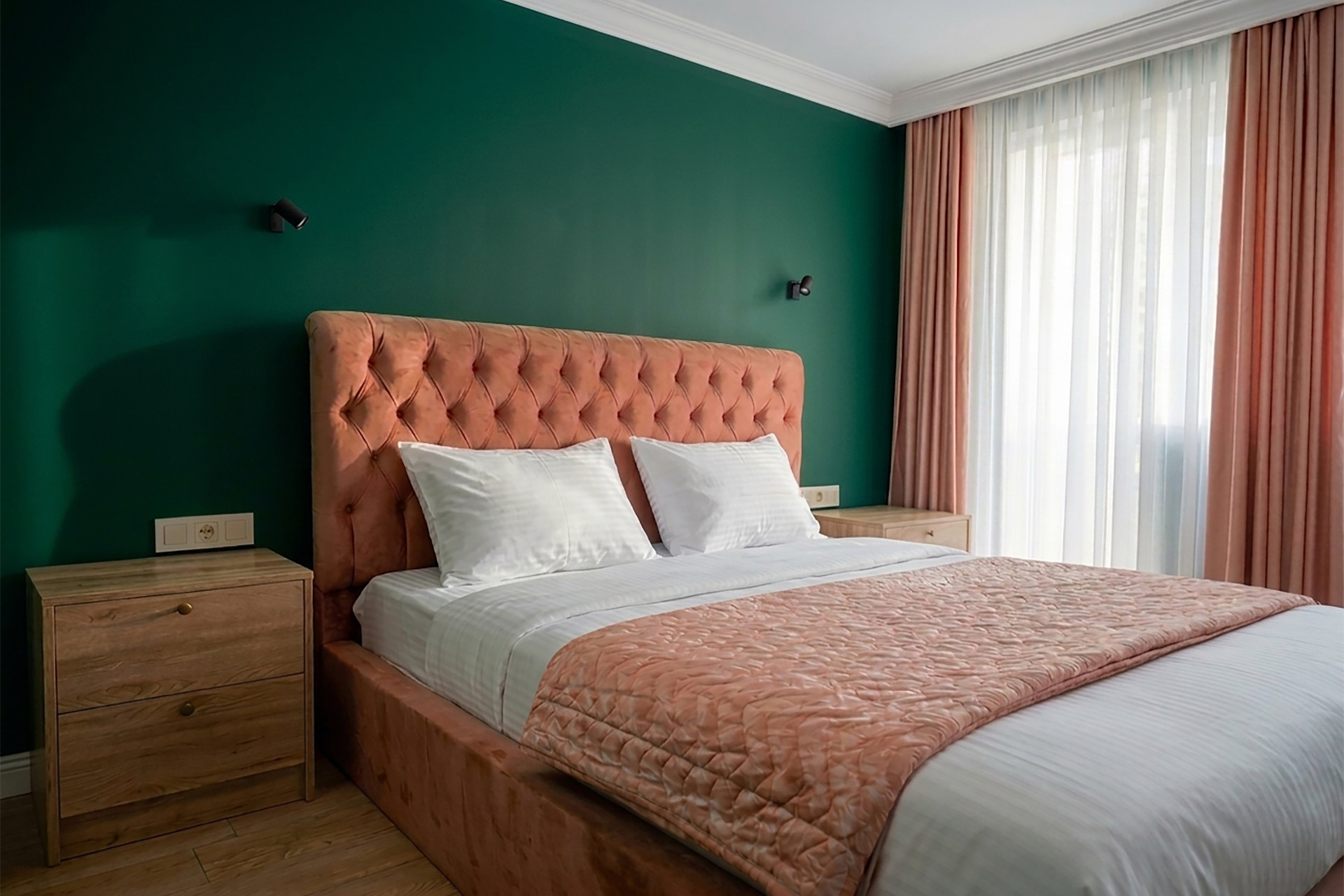 Queen-size bed (160 cm) and quality bedding. Glass door opens to the balcony.