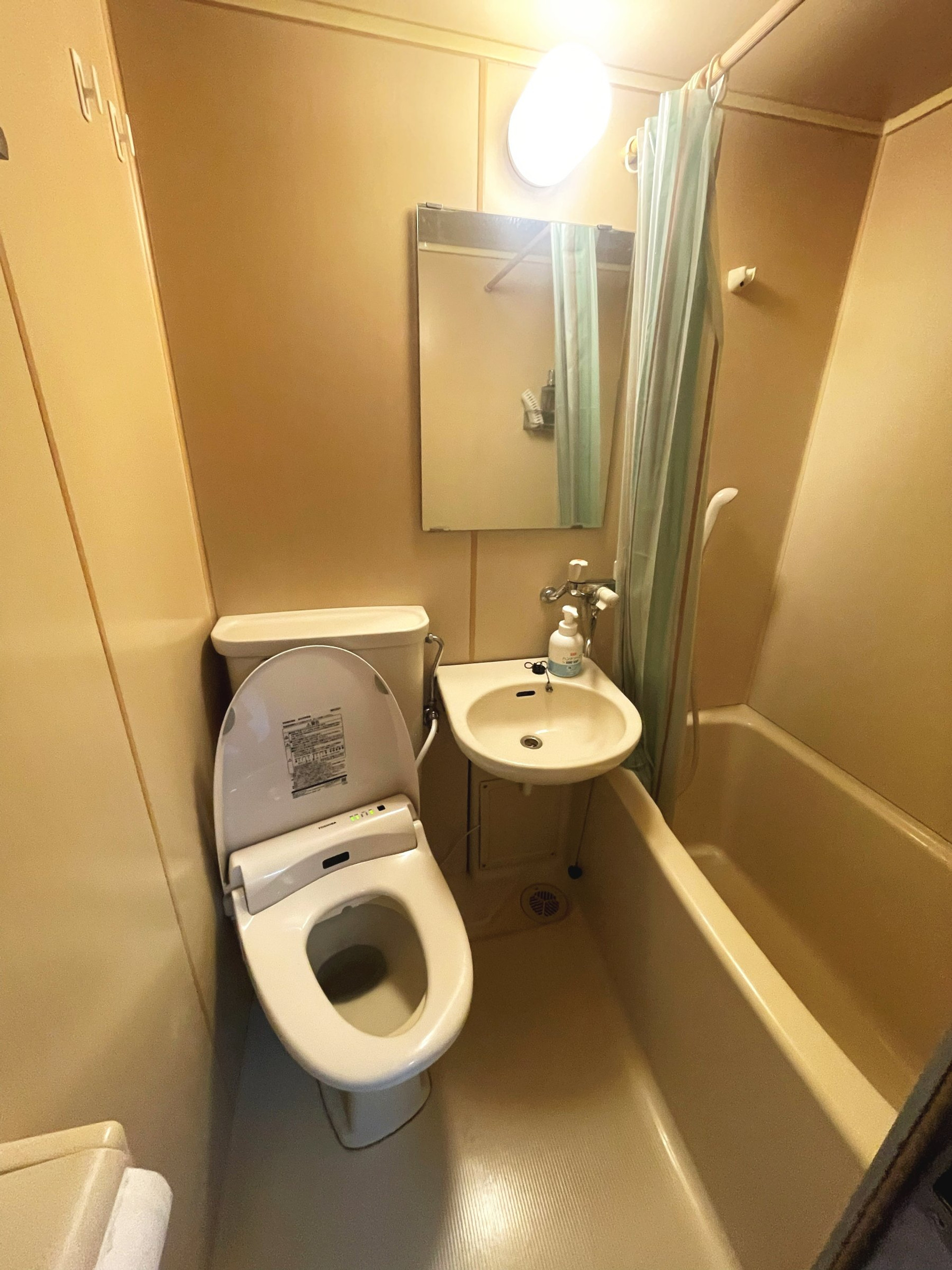 Compact bathroom with tub and toilet