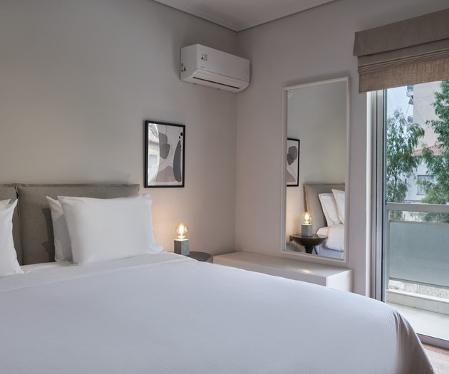 The second bedroom connected to the living room, with a king size bed that can be converted to twins