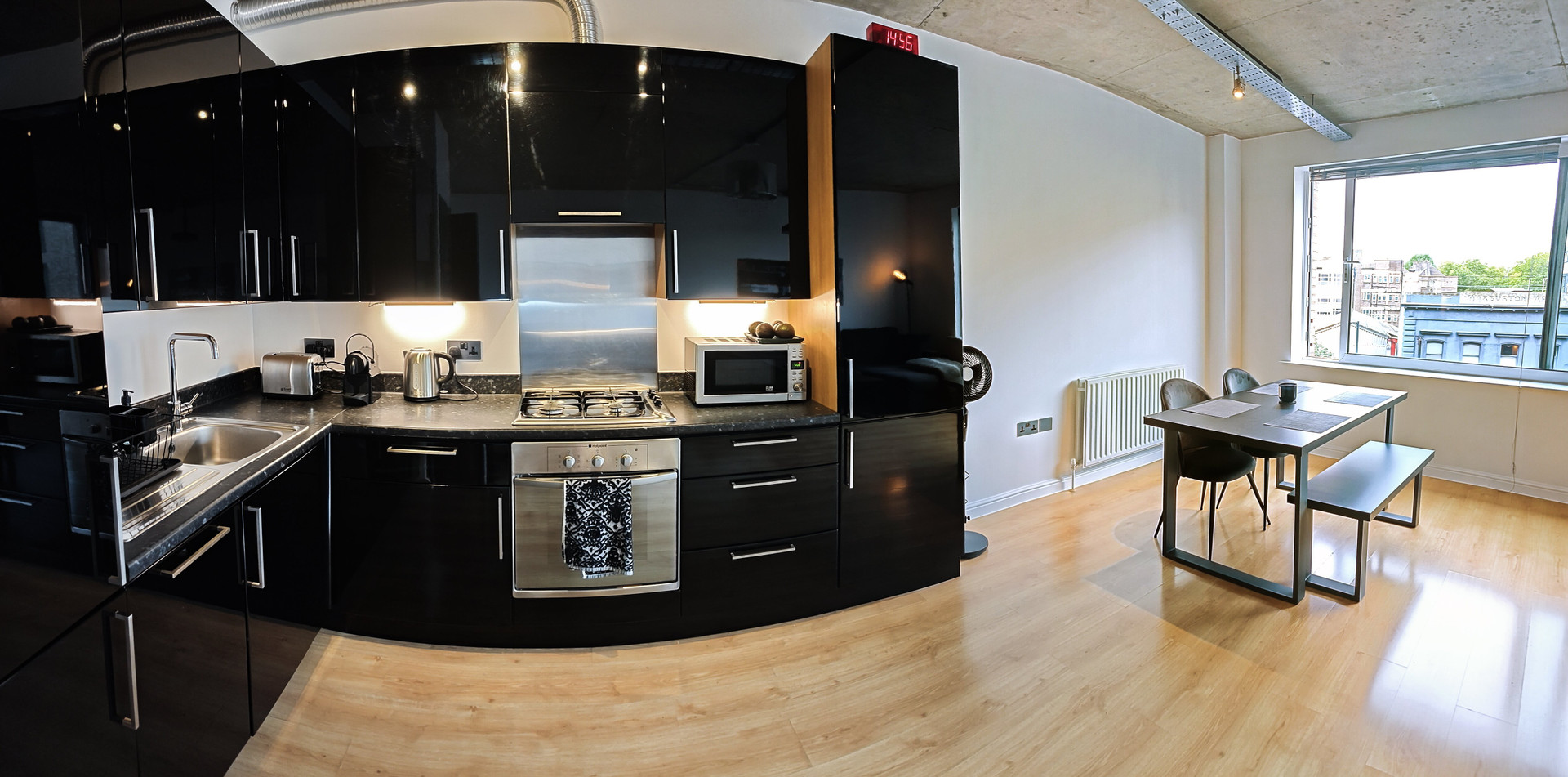 Black kitchen with dining area