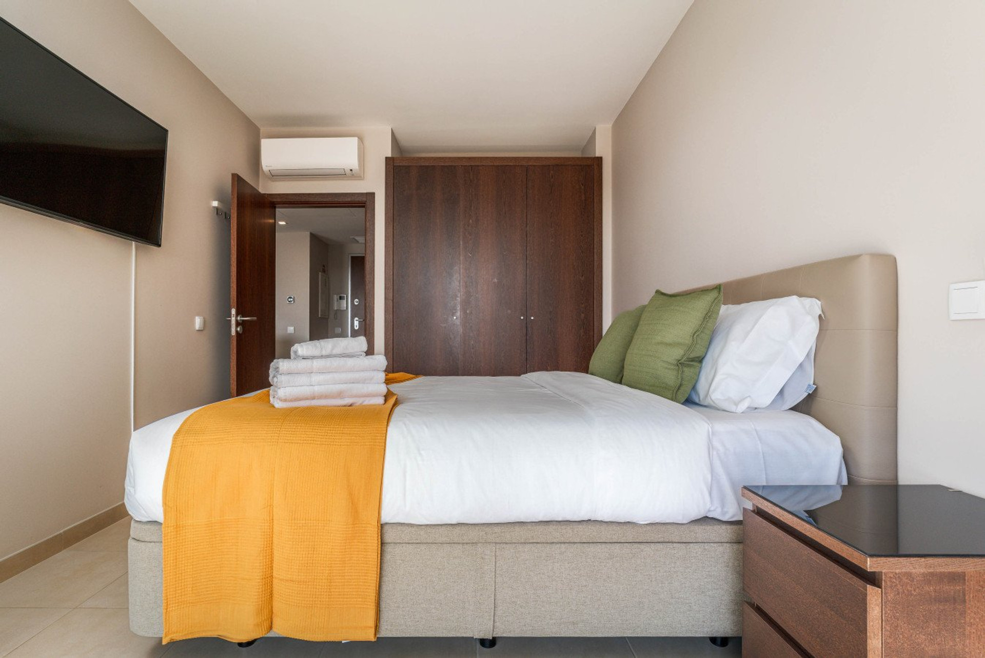 Cozy bedroom with wardrobe and TV