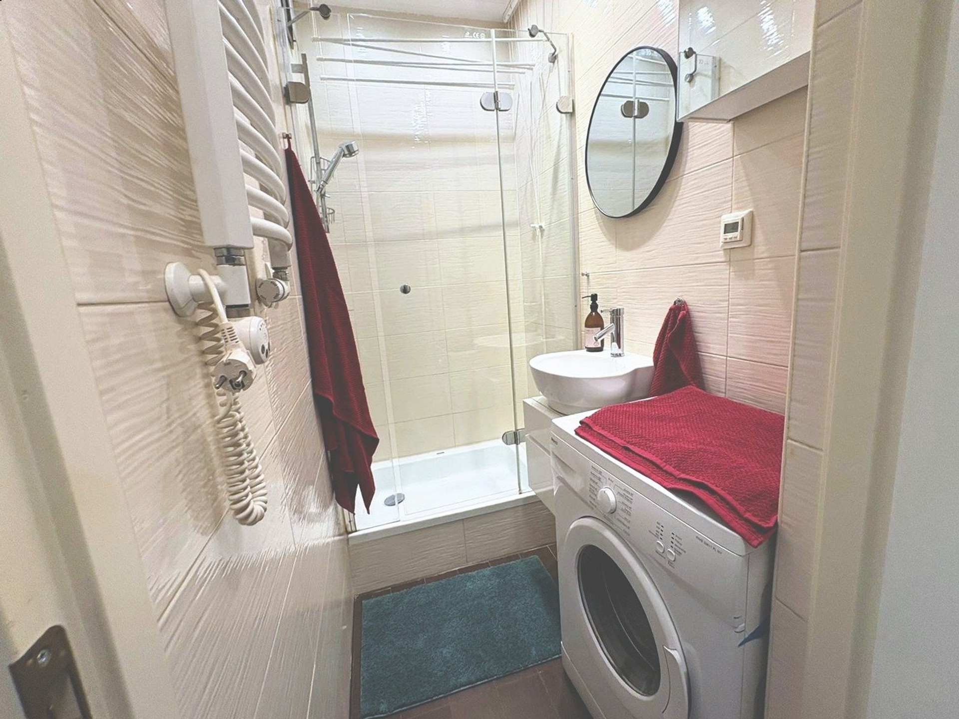 Bathroom with shower and washing machine