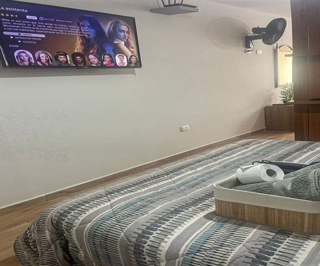 Bedroom with TV and bed