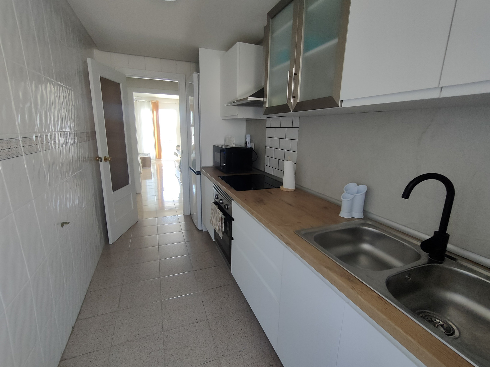 Kitchen with sink and hallway