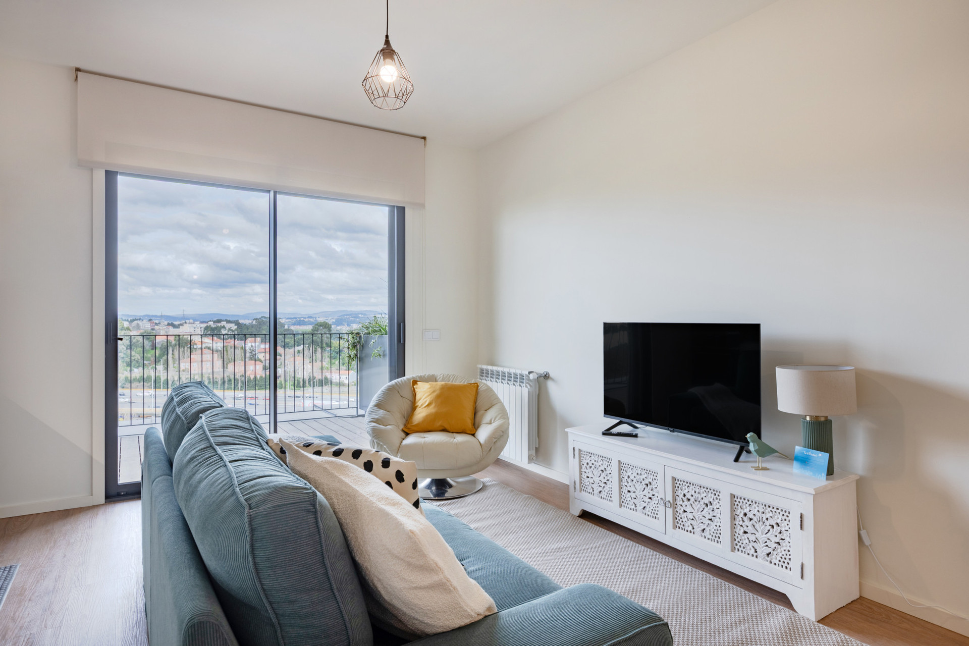 Living Area with a TV and Sofa that opens to a Balcony