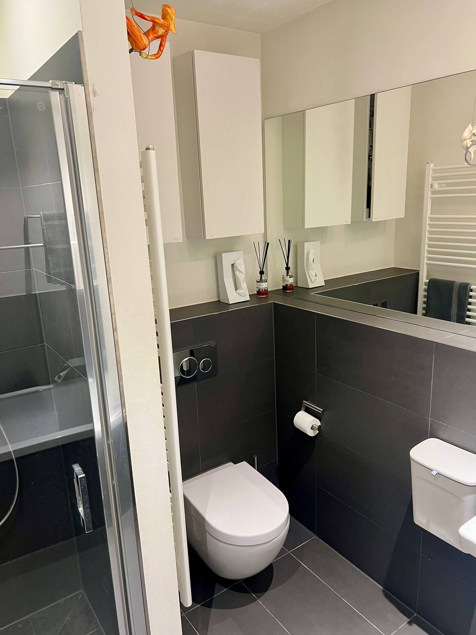 Dark tiled bathroom with shower