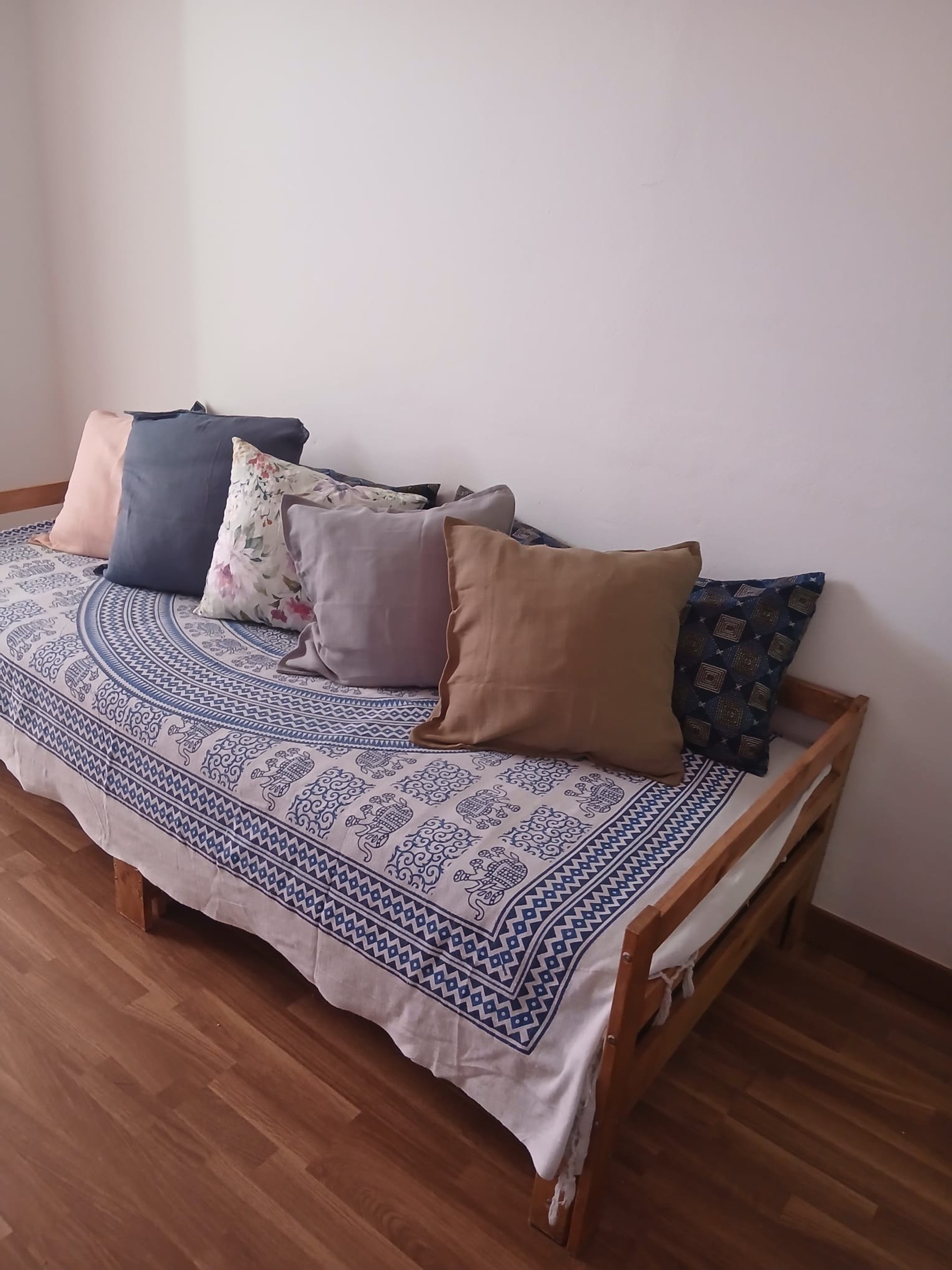 Daybed with cushions, wooden floor
