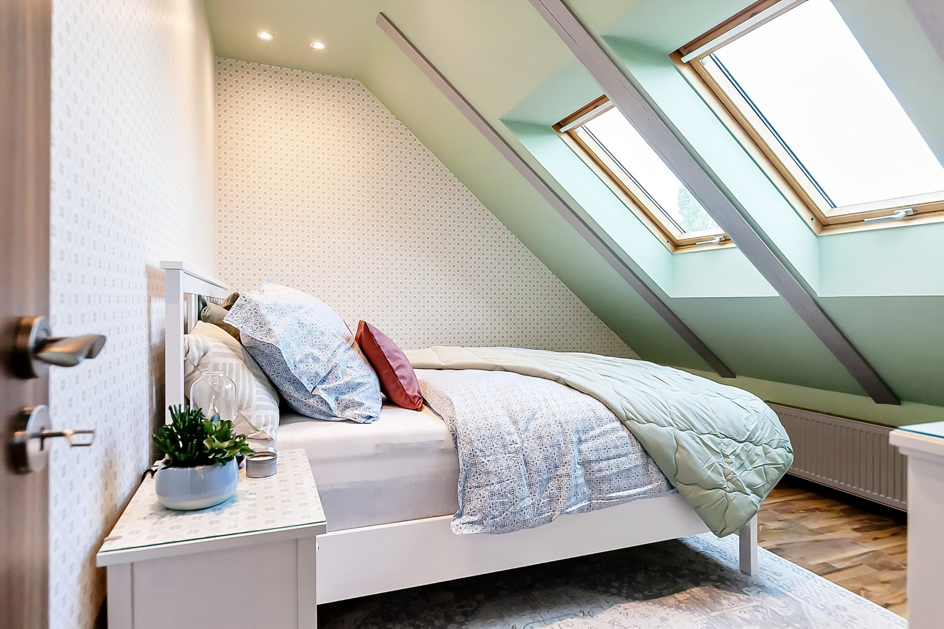 Cozy bedroom with skylight sloped ceiling