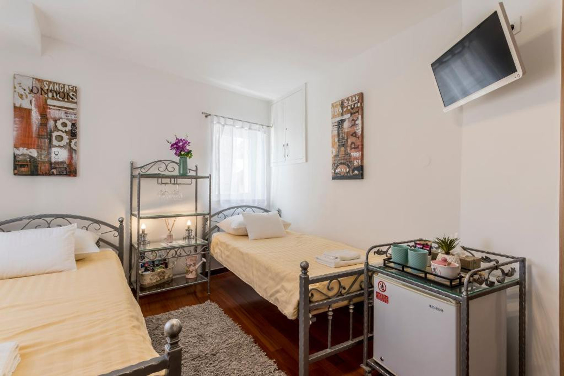Twin beds, mini fridge and TV.