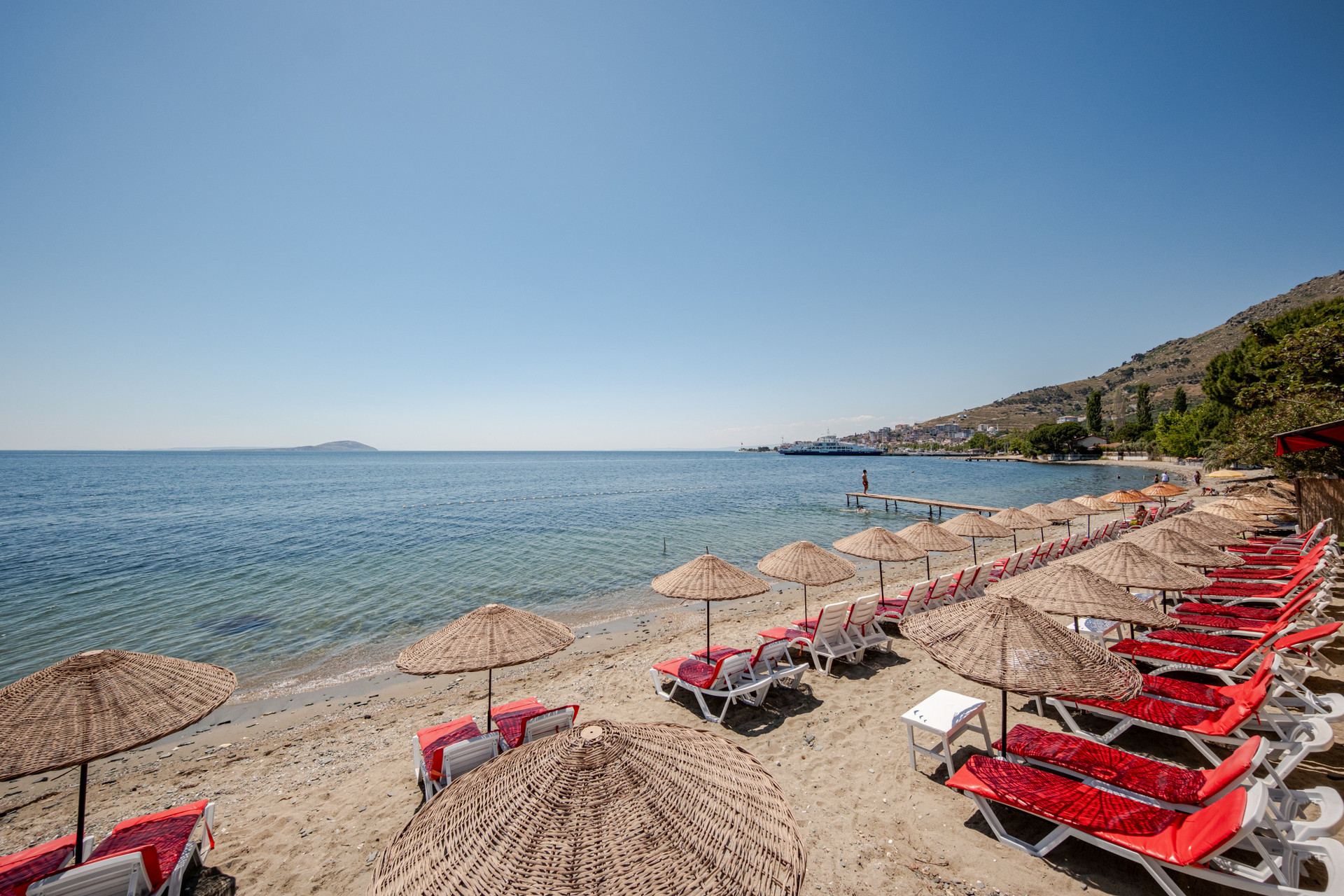 Private beach with umbrellas and loungers