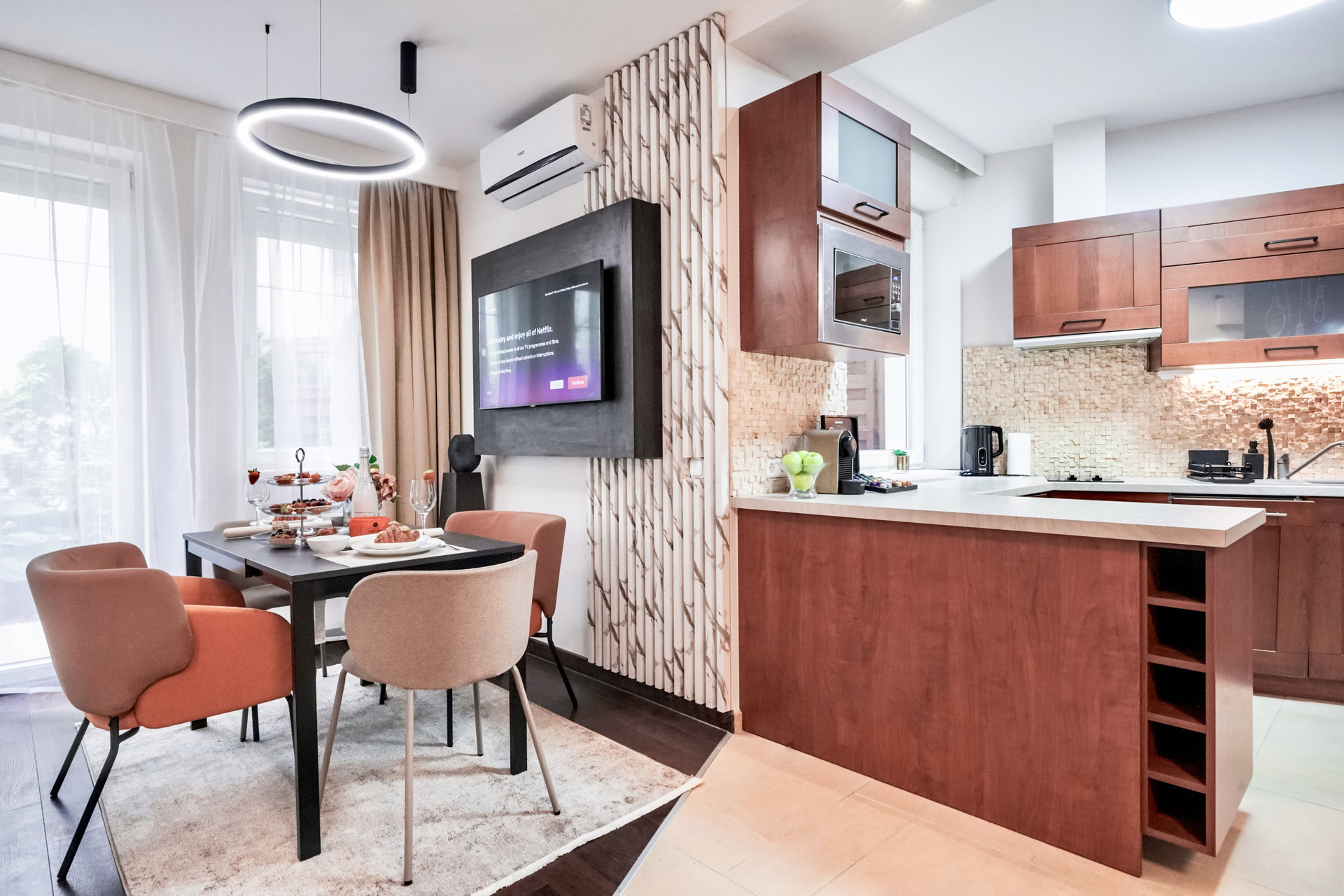 Modern living room with fully equipped kitchen and elegant dining area