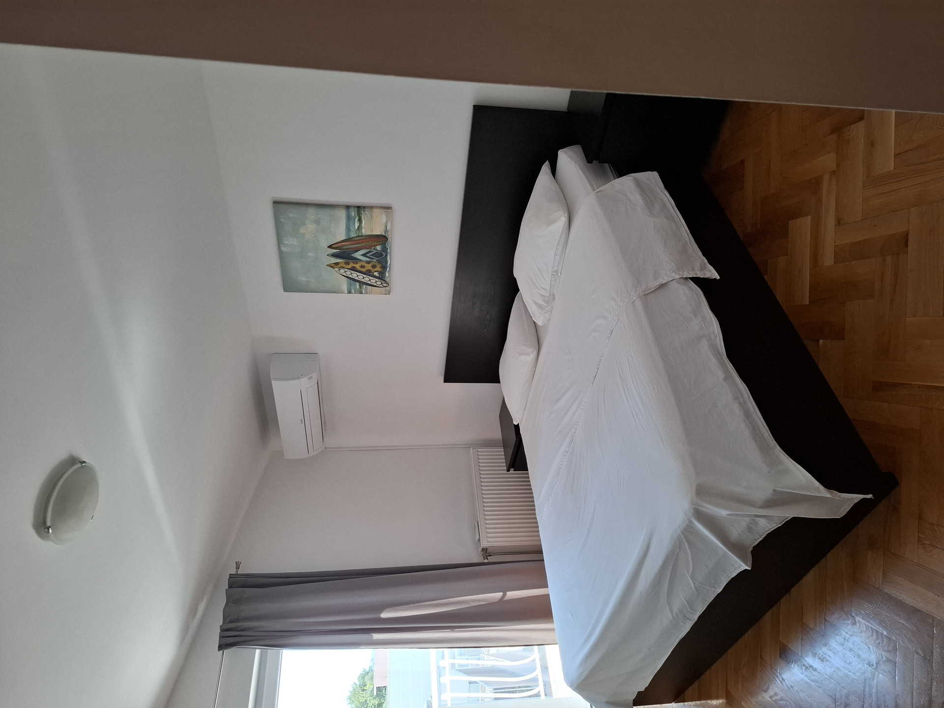 Bedroom bed with artwork
