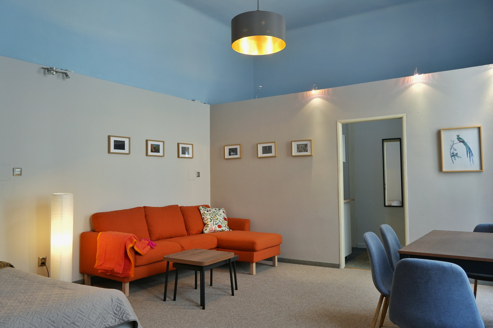 Living room with orange sofa and dining area