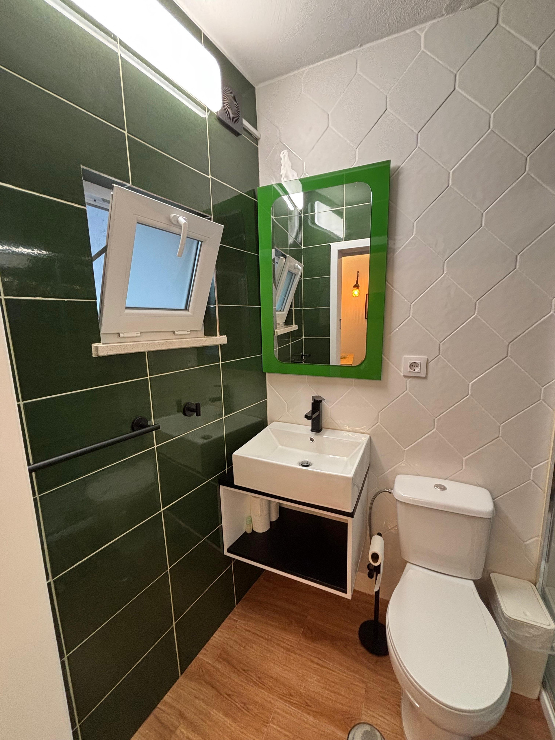 Green tiled bathroom sink