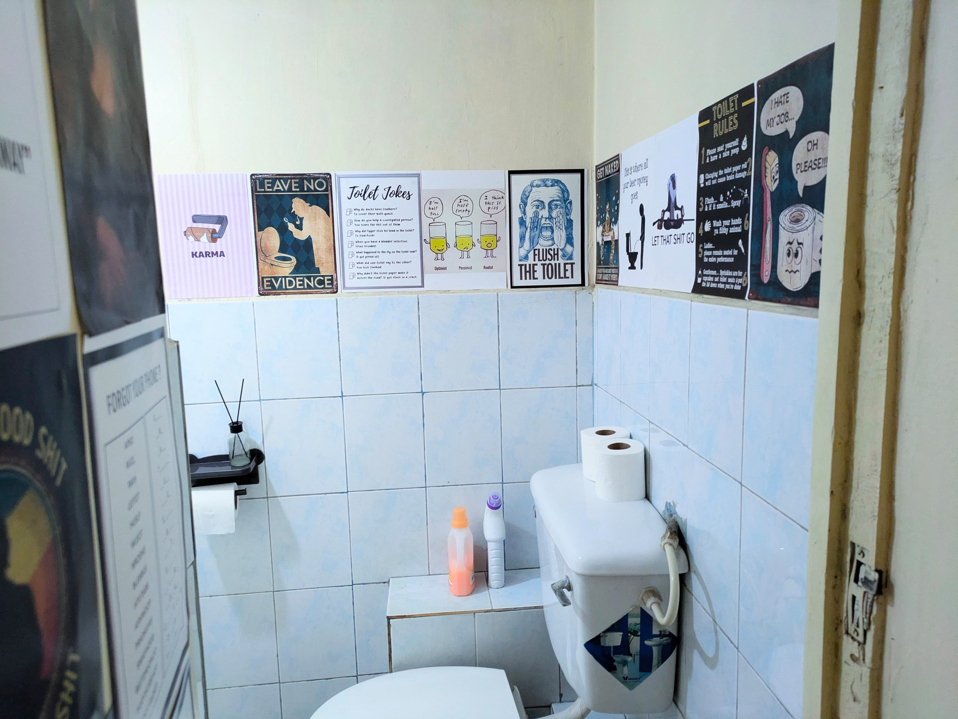 Bathroom toilet with humorous posters