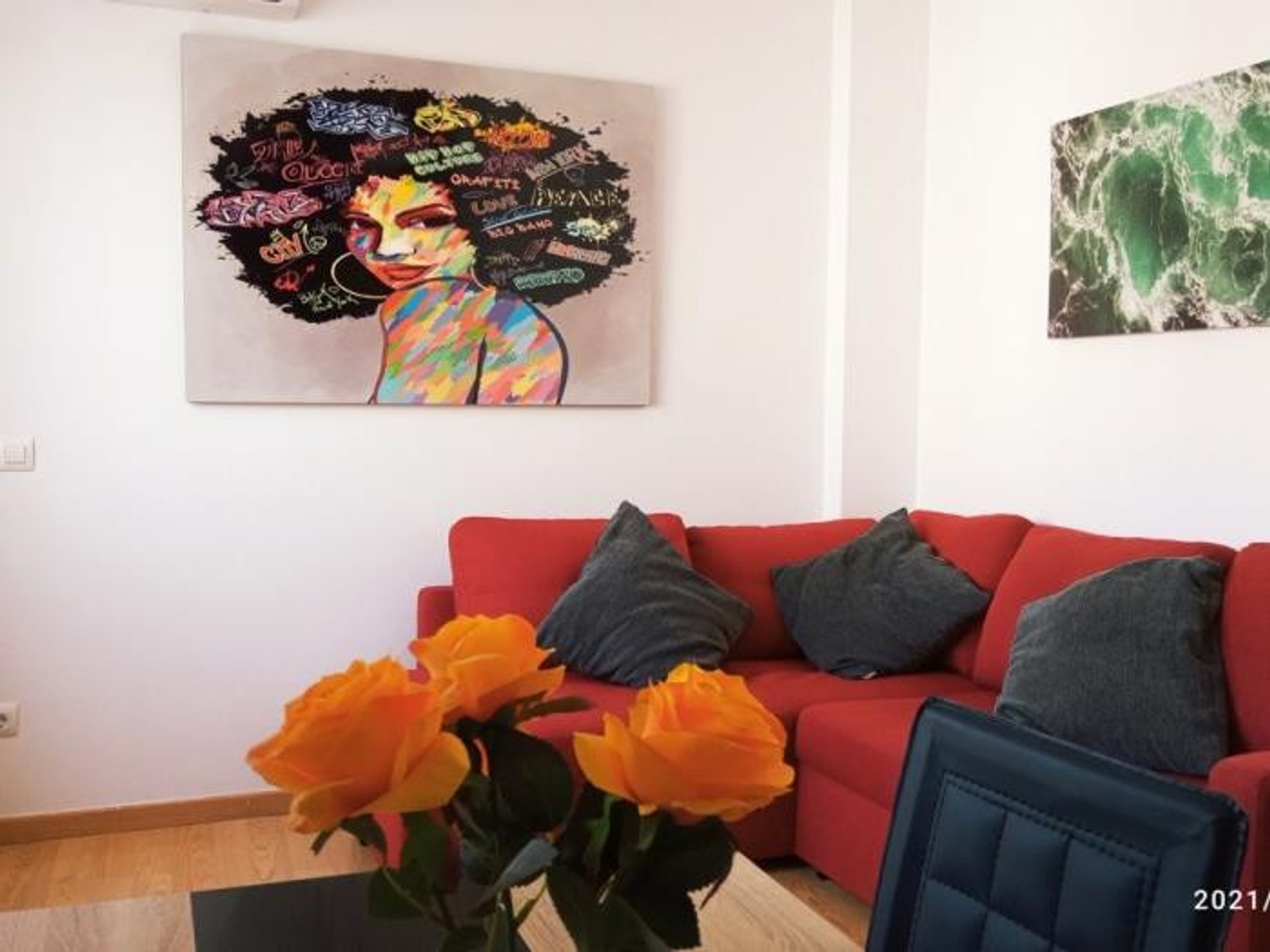 Living room with red sofa and art