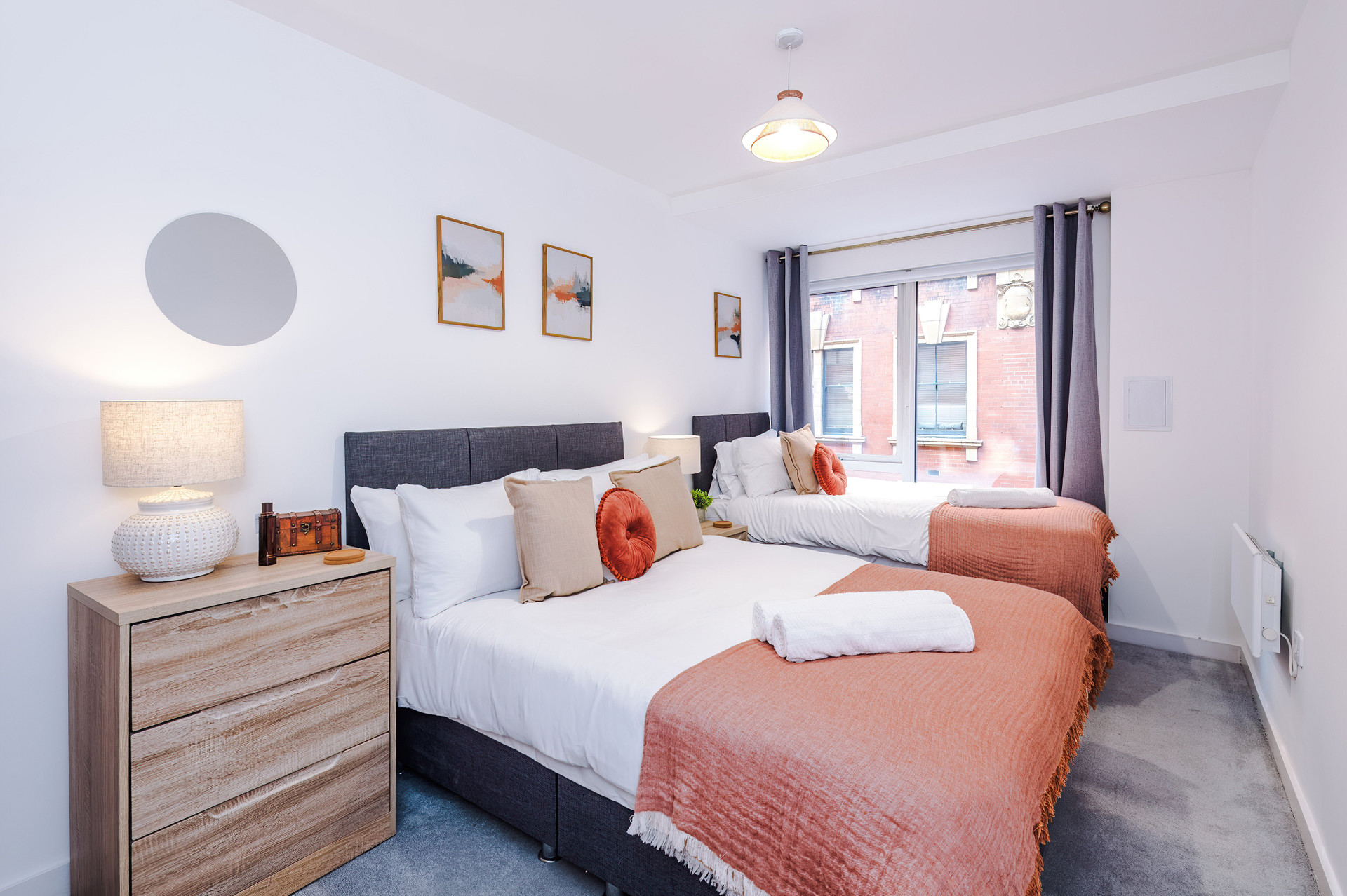 Twin beds with coral throws