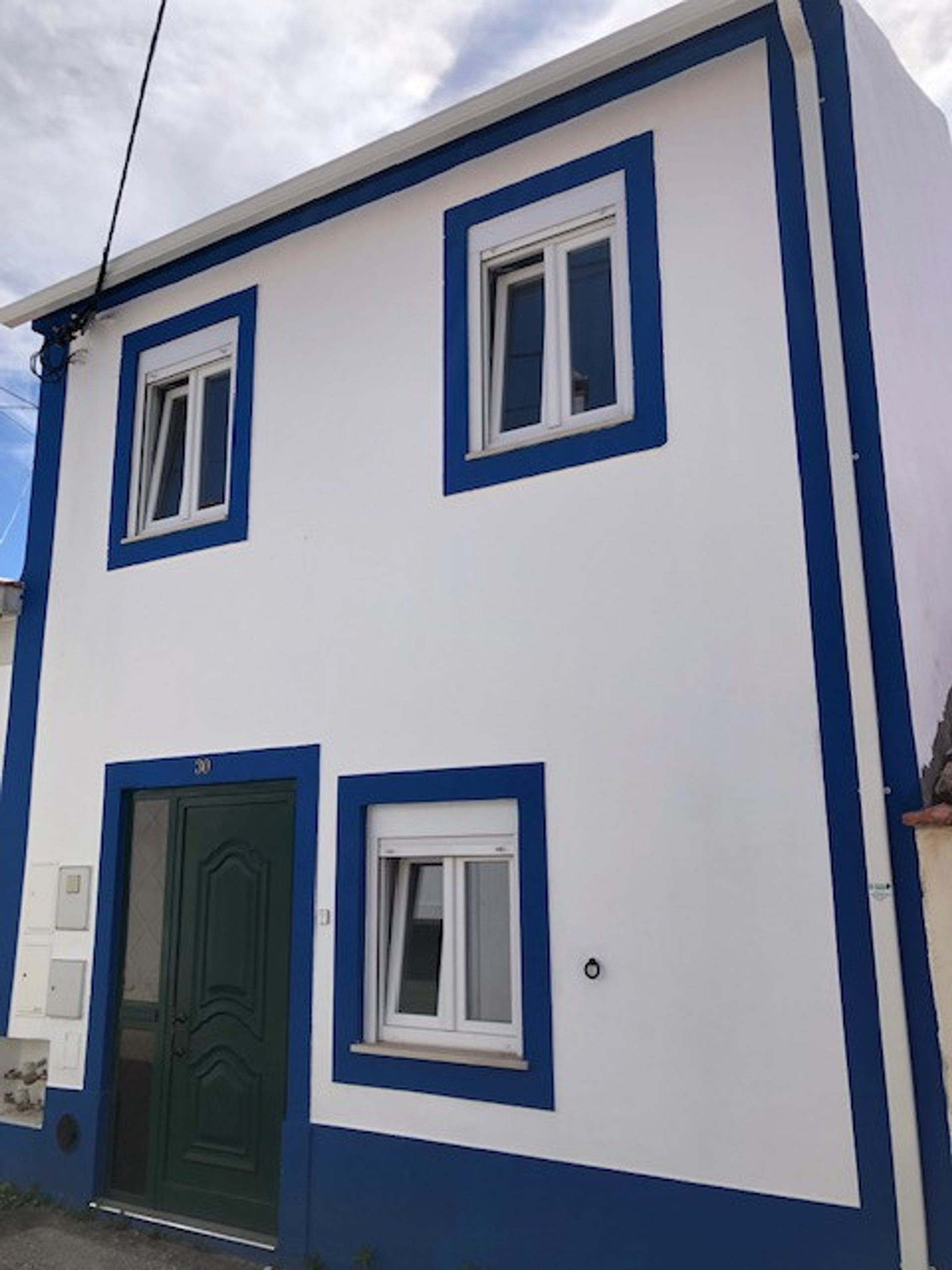 Façade with main entrance and studio window