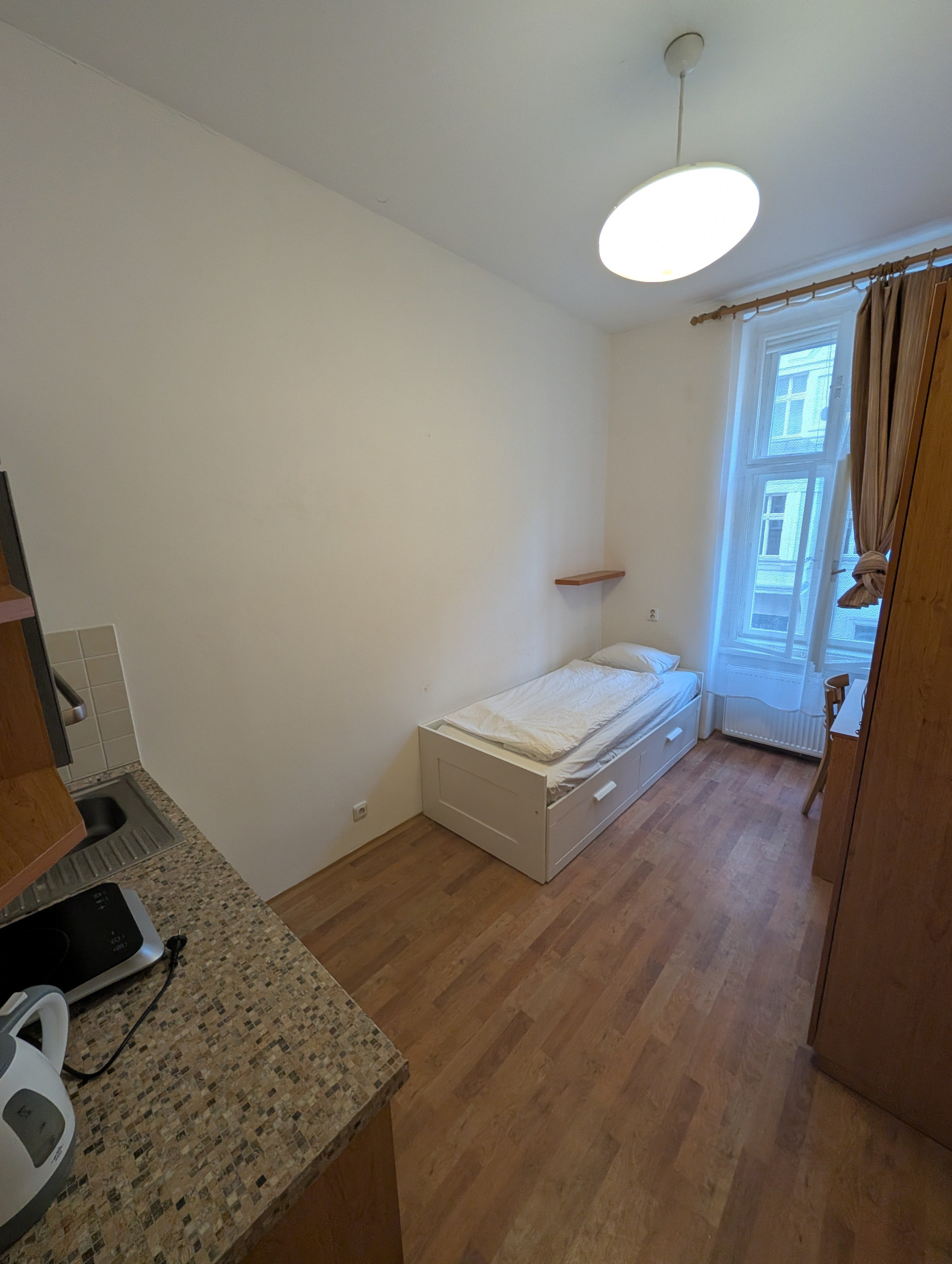 Single bed with kitchenette area