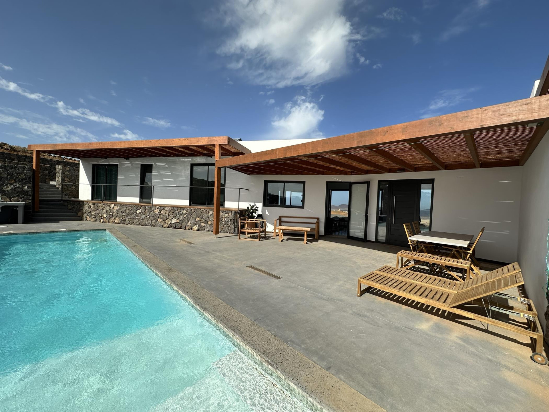 Pool terrace with sun loungers pergola