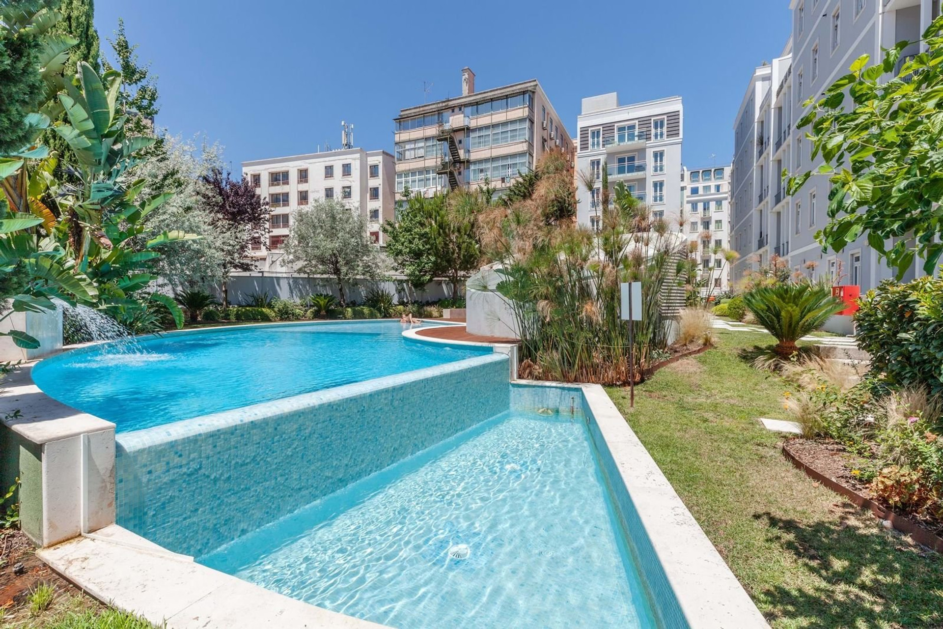 Outdoor pool with waterfall feature