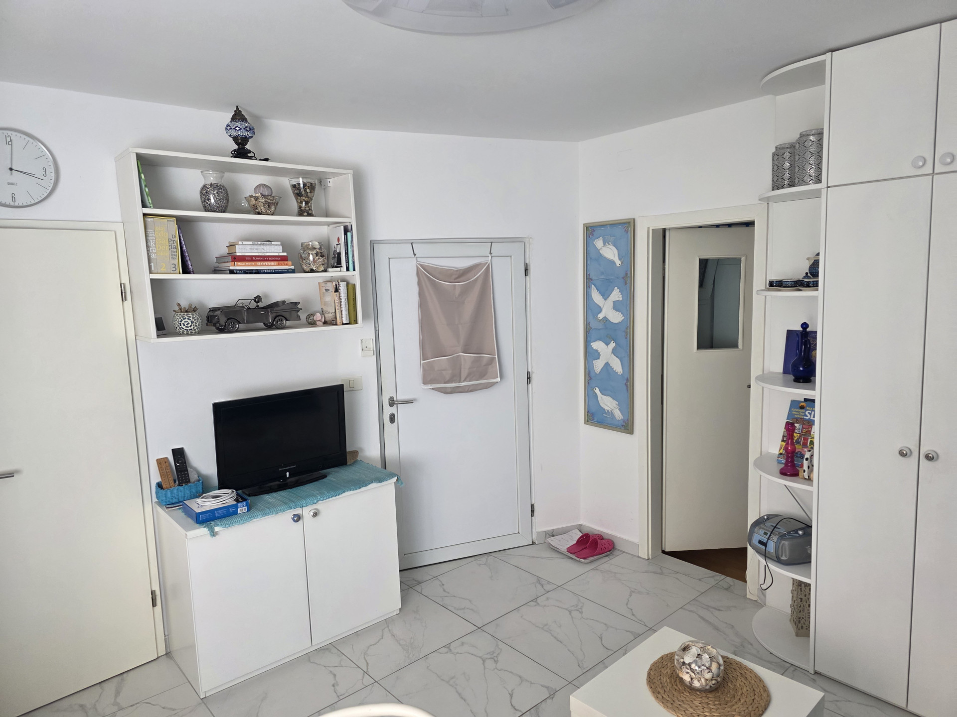 Living room with TV and shelving