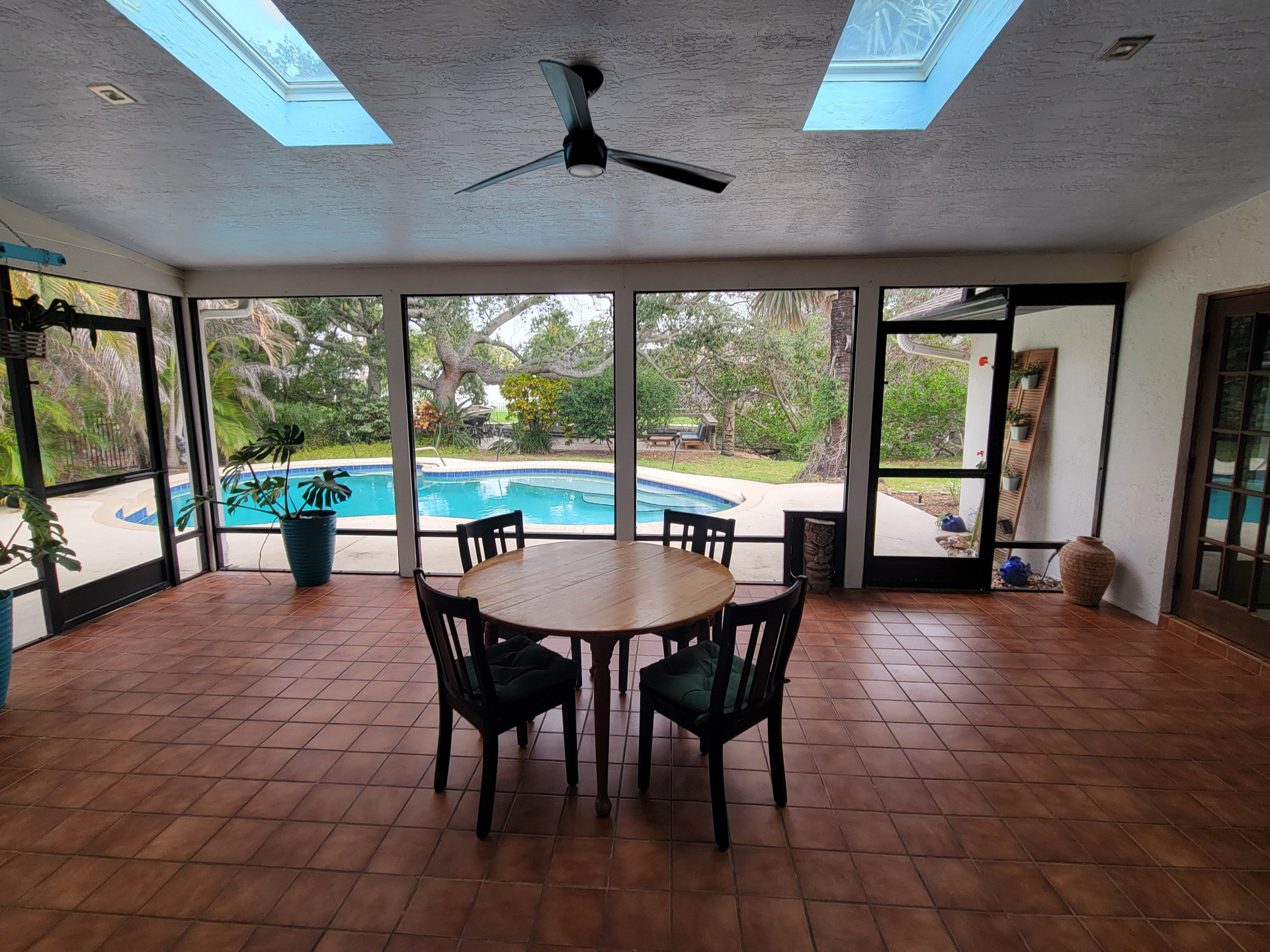 350 sqft screened porch with skylights and great views of the large backyard, pool and canal