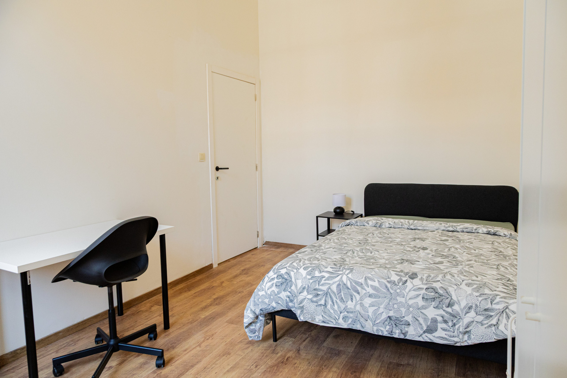 Bright bedroom with desk and bed