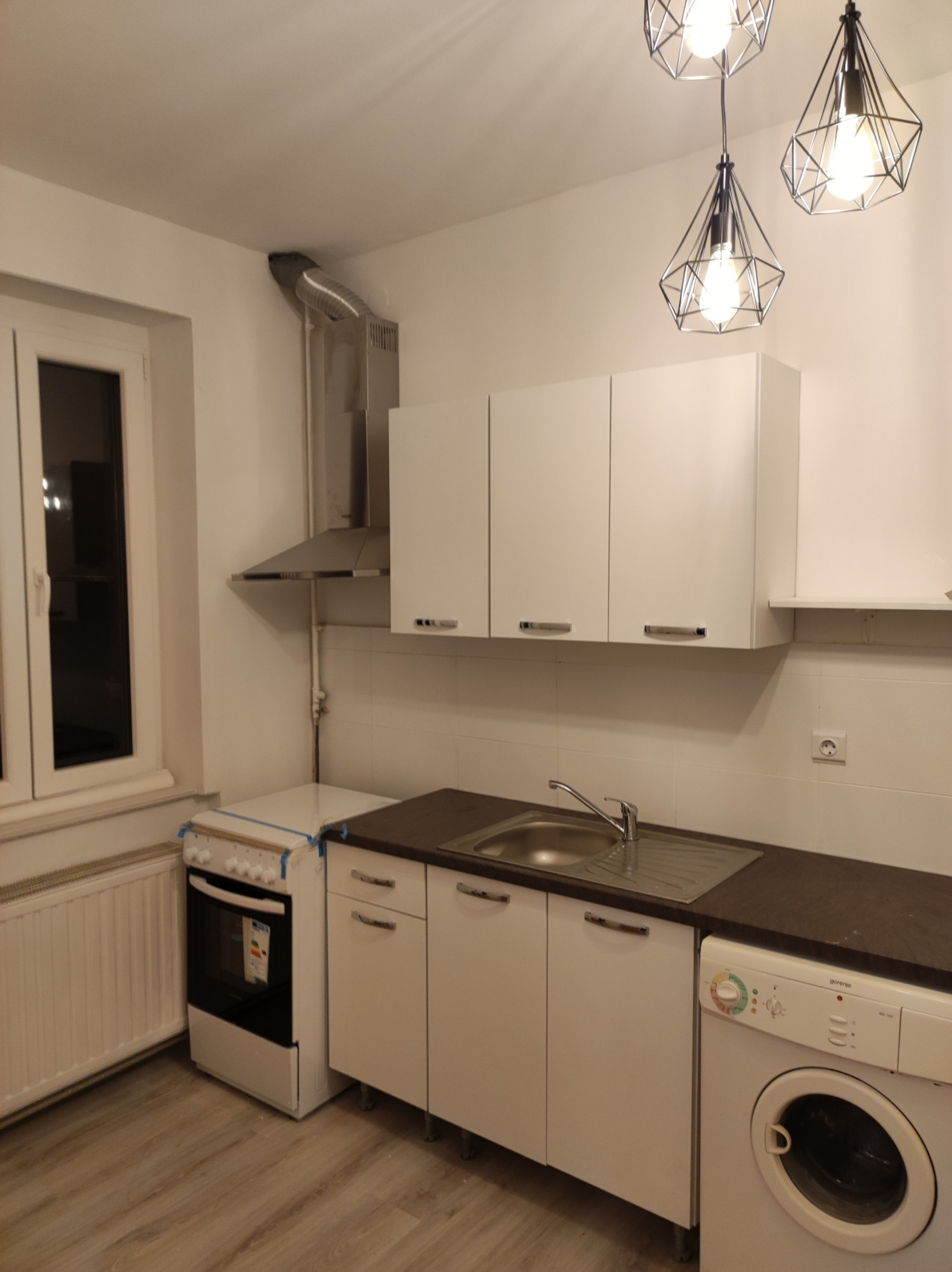 Kitchen with stove and washing machine