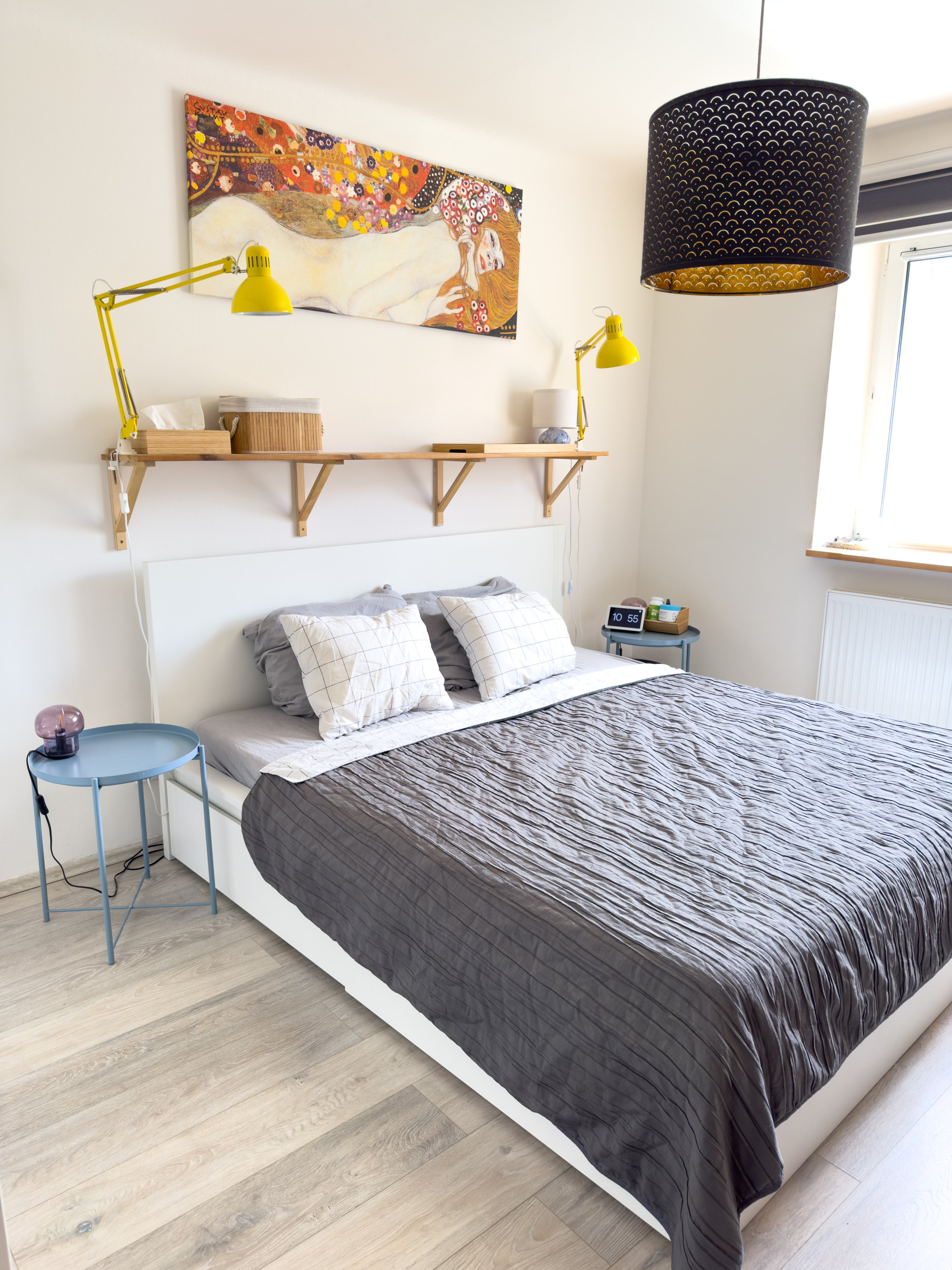 Stylish bedroom with art above bed
