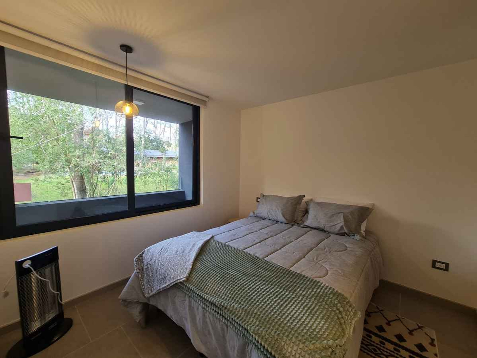 Quiet, minimalist bedroom for deep rest and productivity. Comfortable double bed, peaceful forest views, and a calm atmosphere — perfect for recharging between work sessions and outdoor adventures.