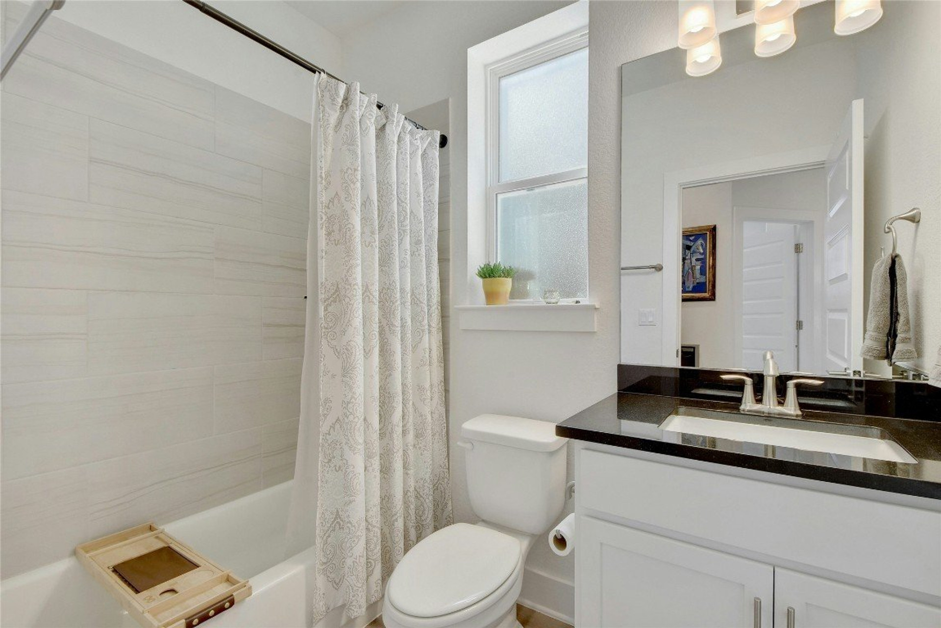 Clean bathroom with tub shower