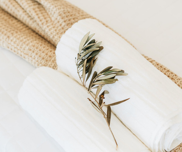 Rolled towels with olive branch