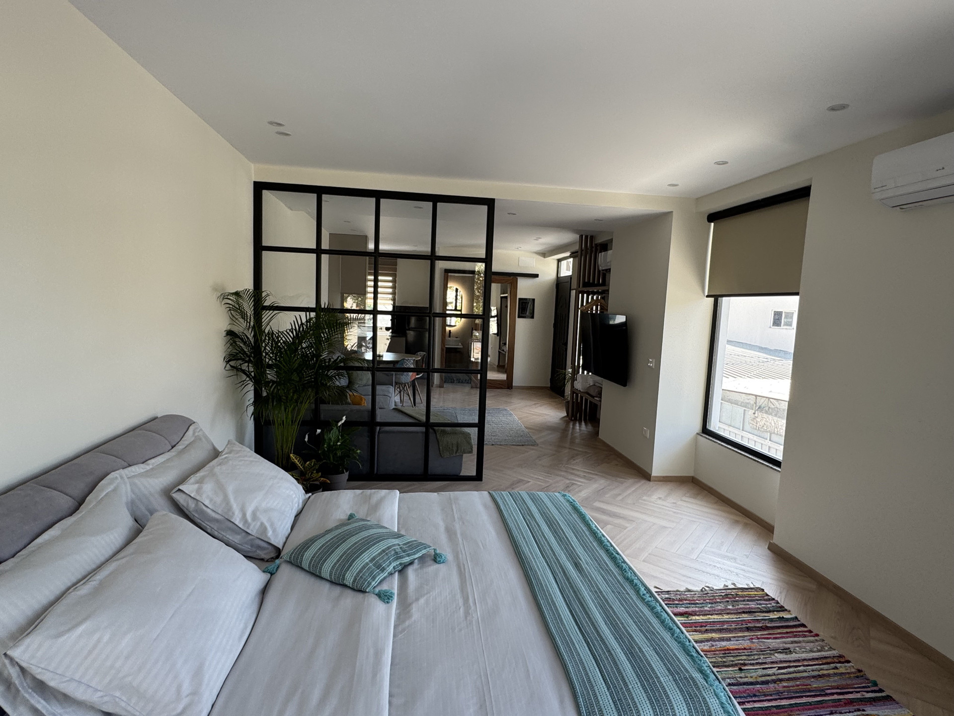 Bed facing living area and TV
