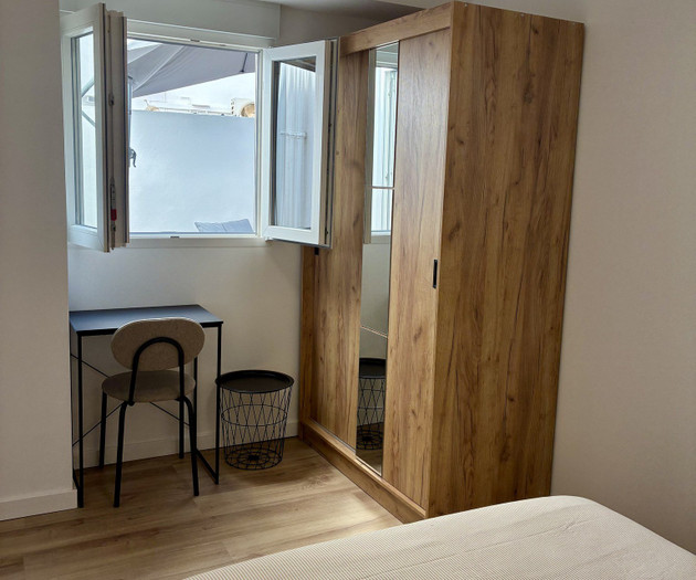Bedroom with desk and mirrored wardrobe