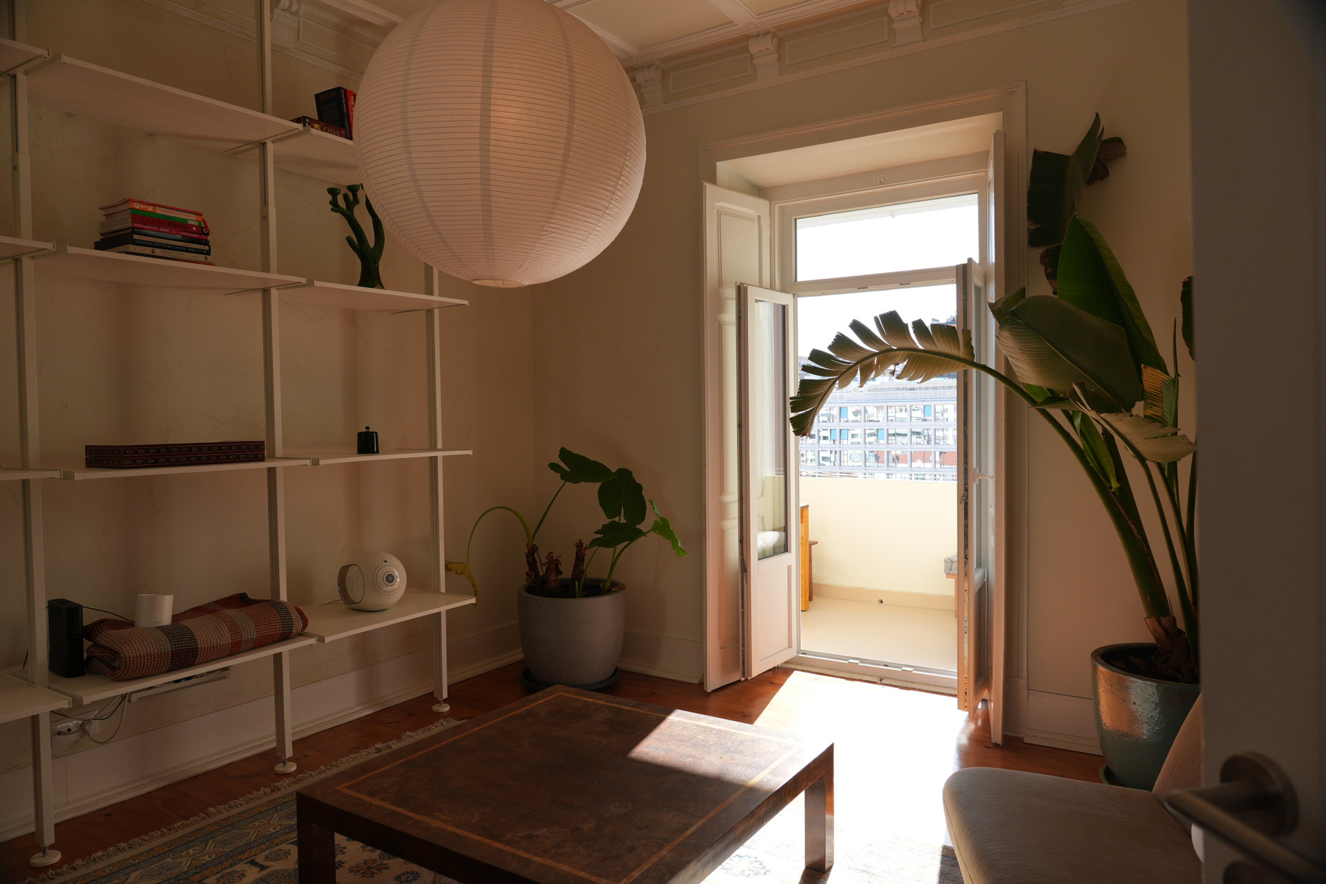 Living area with shelves and balcony access