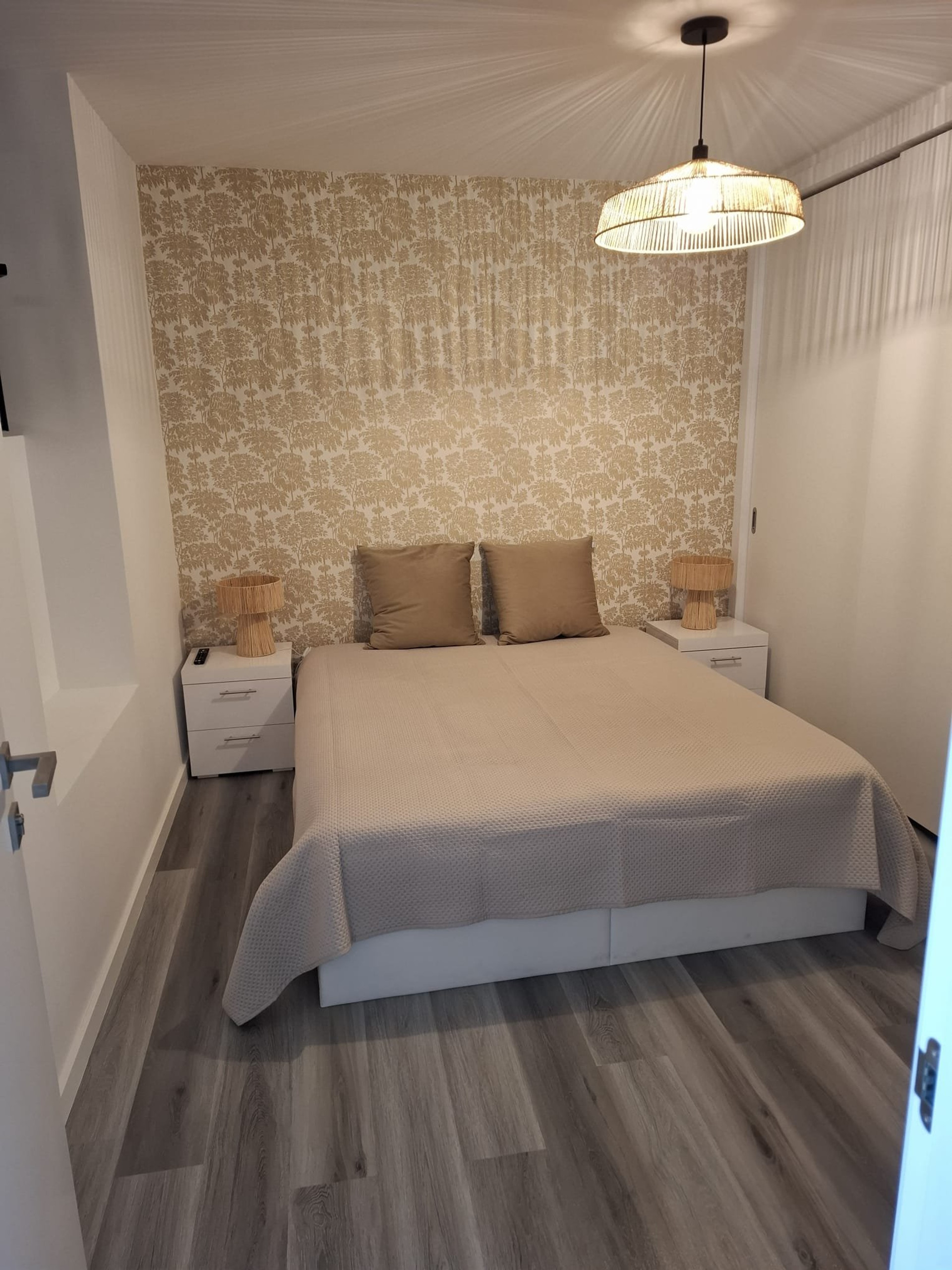 Bedroom with beige floral wallpaper