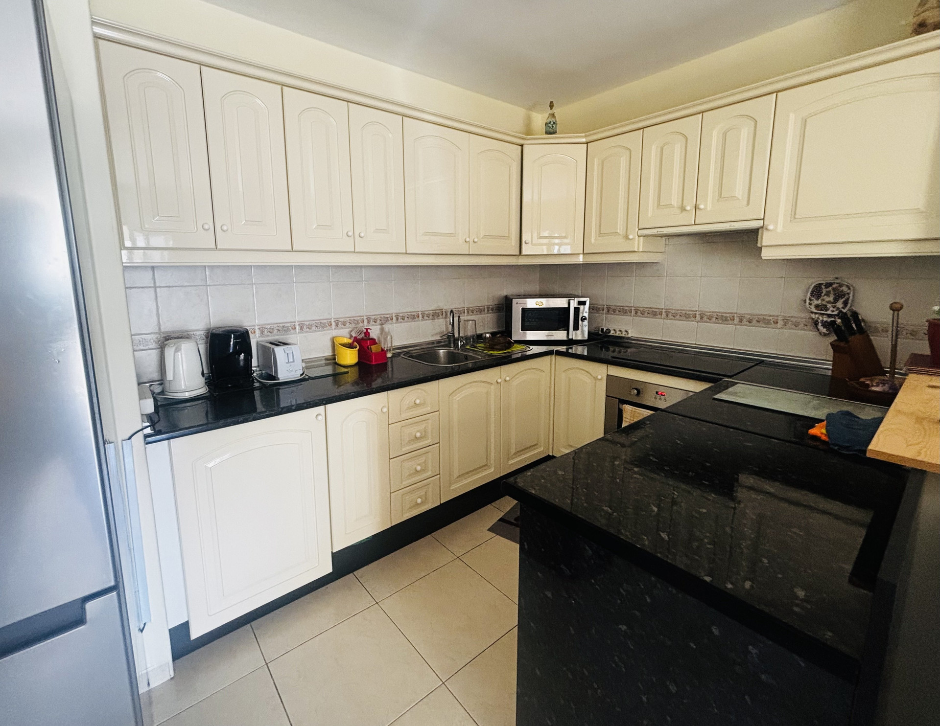 White kitchen with dark countertops