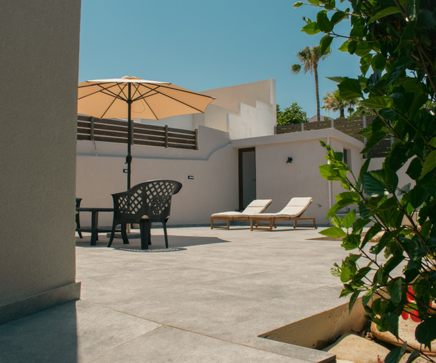 Patio with umbrella and loungers