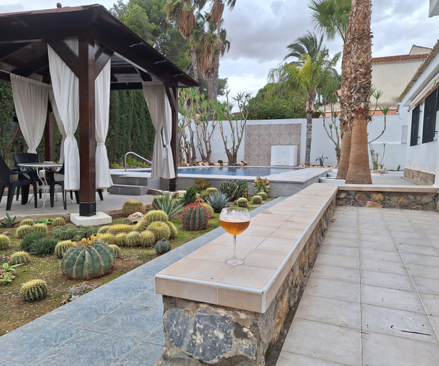 Wine glass overlooking garden pool