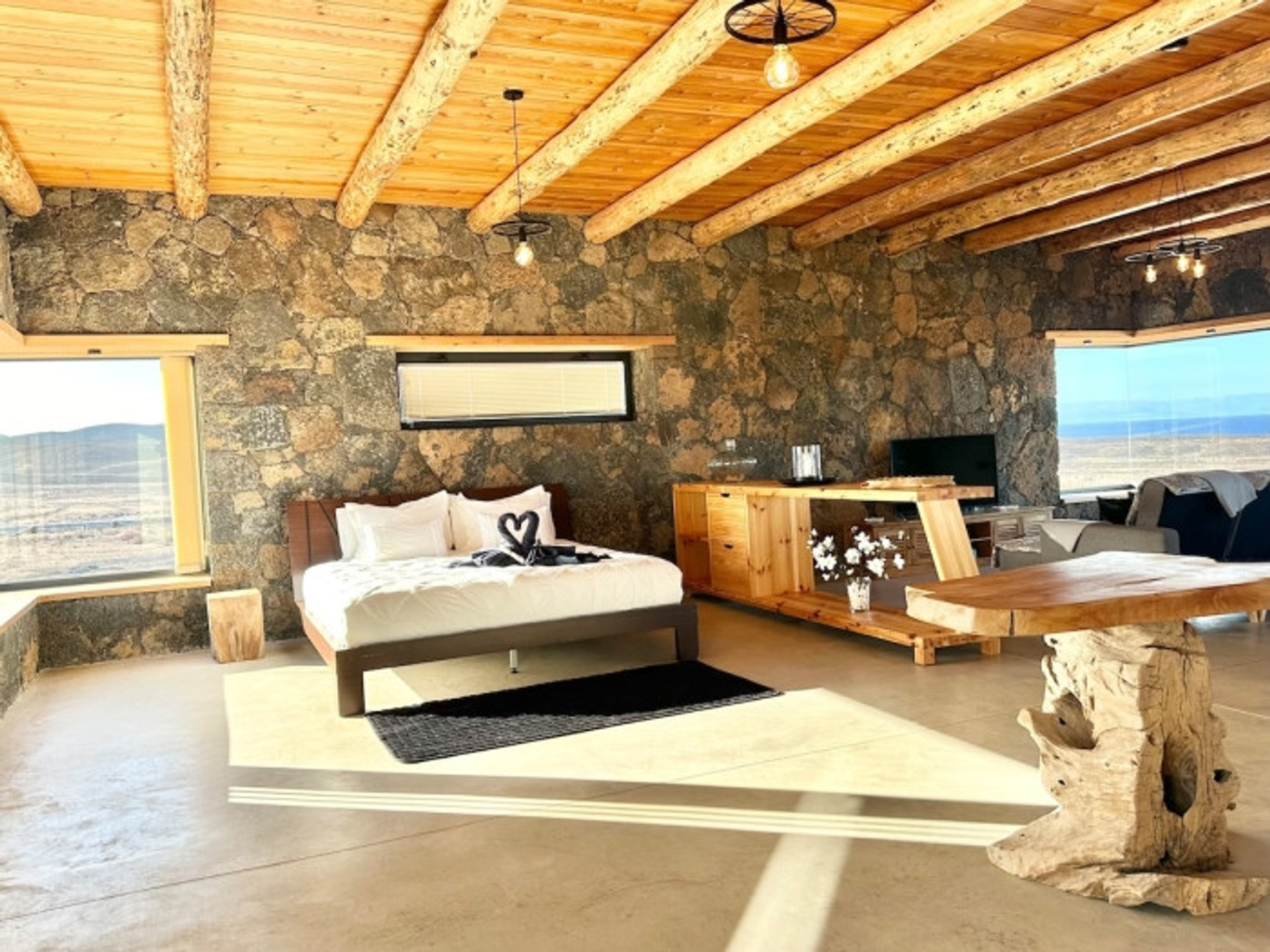 Bedroom with wooden ceiling stone walls