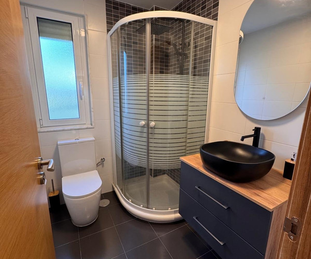 Bathroom with corner shower stall