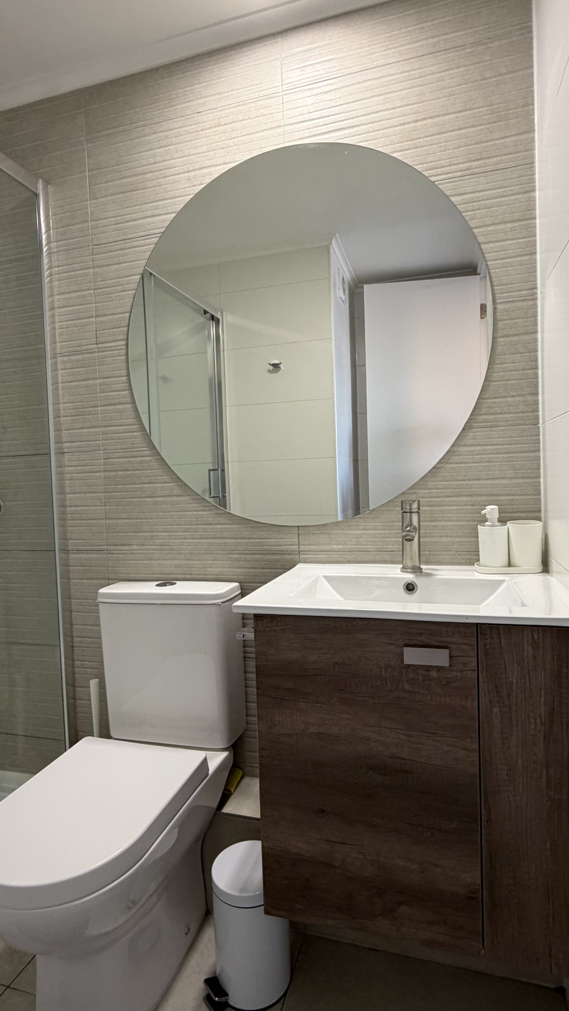 Bathroom vanity with round mirror