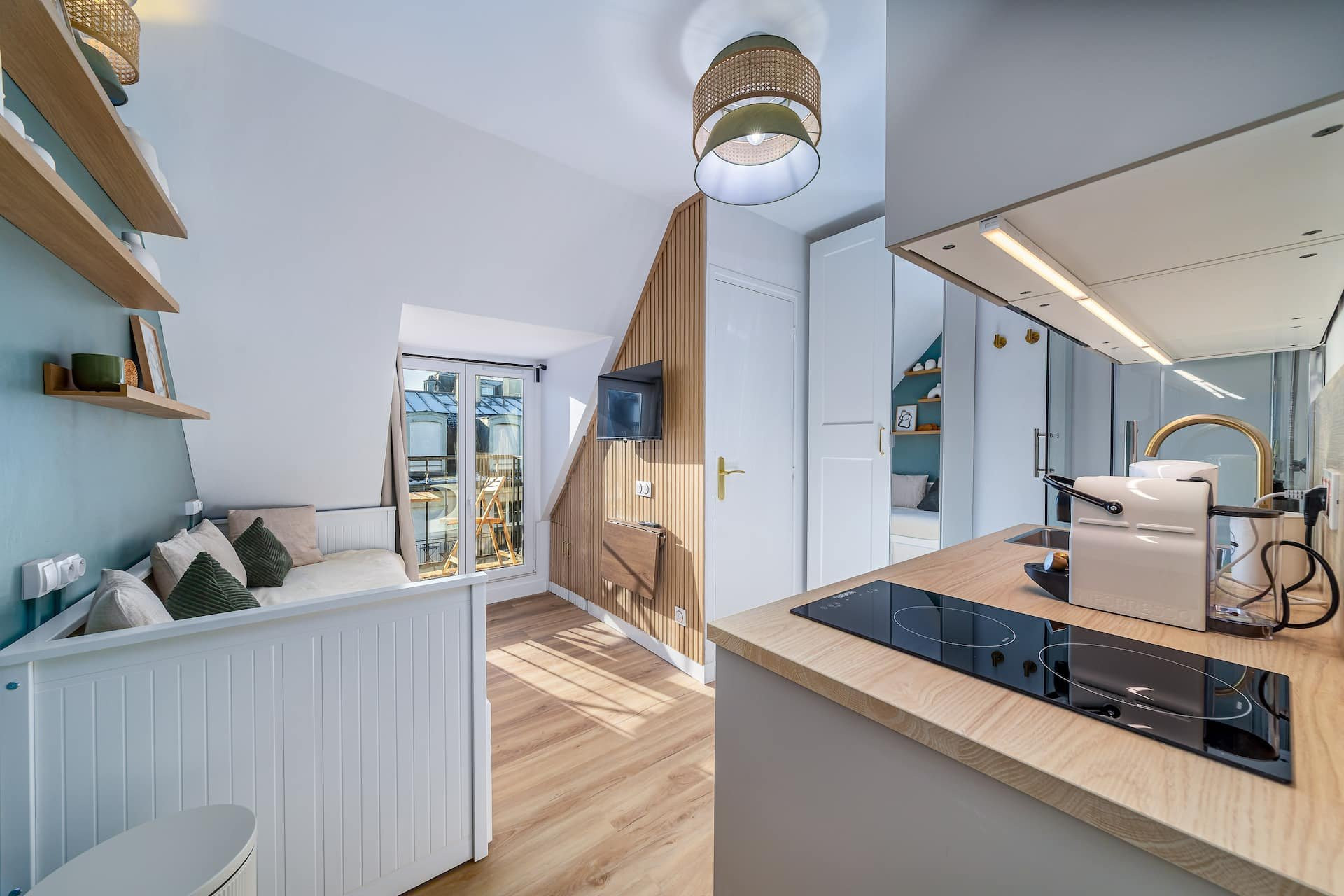 Studio overview with kitchen and bed